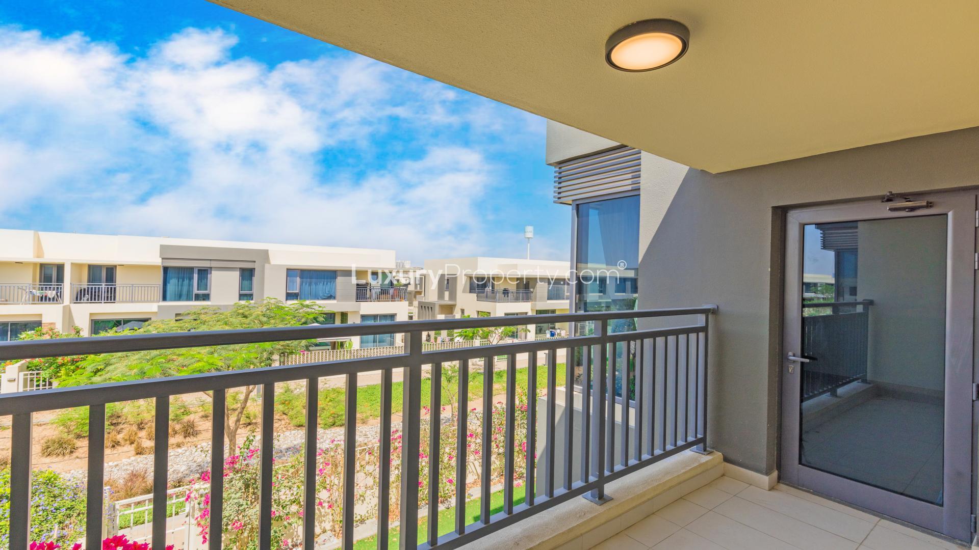 Empty living room with large windows overlooking landscaped yard in Dubai Hills Estate townhouse