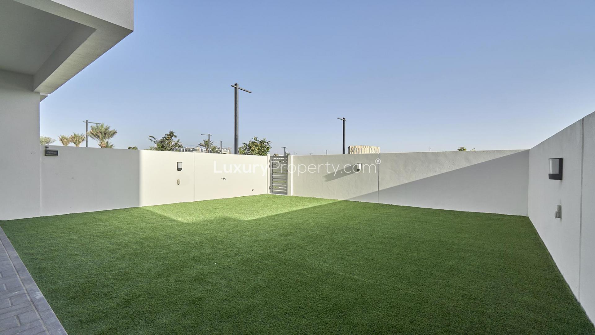 Spacious backyard with artificial grass in Maple townhouse, Dubai Hills Estate