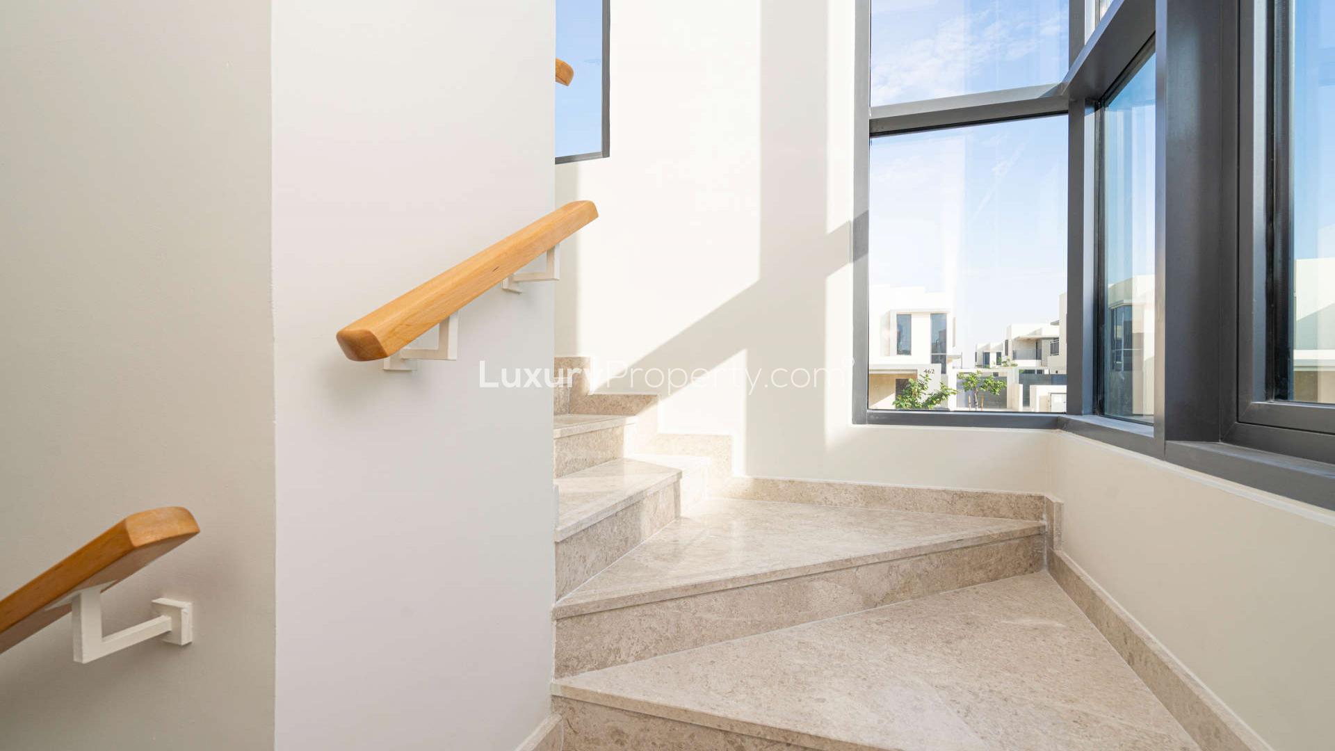 "Modern townhouse balcony view in Maple at Dubai Hills Estate, available for rent.",Modern staircase with natural light in Maple at Dubai Hills Estate townhouse
