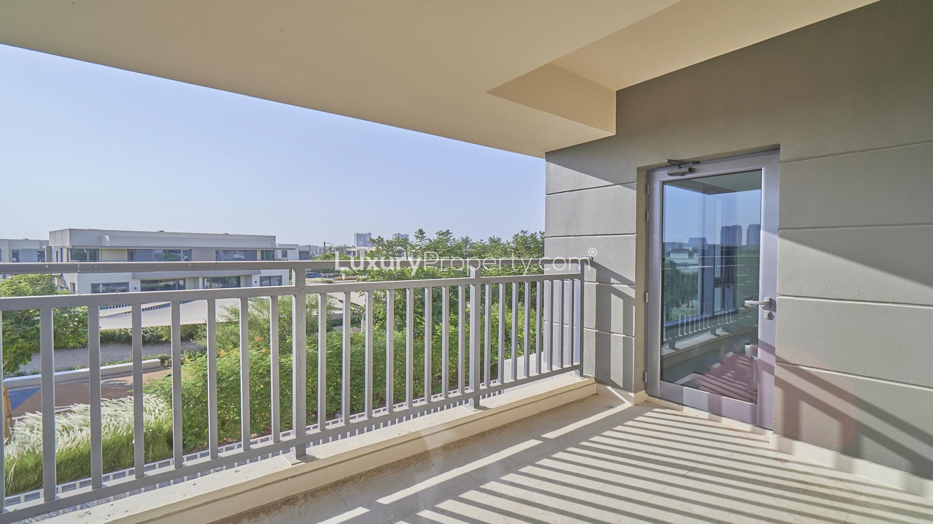 "Balcony view of townhouse in Maple at Dubai Hills Estate, available for rent.",Bright, empty room with large window in Maple townhouse, Dubai Hills Estate