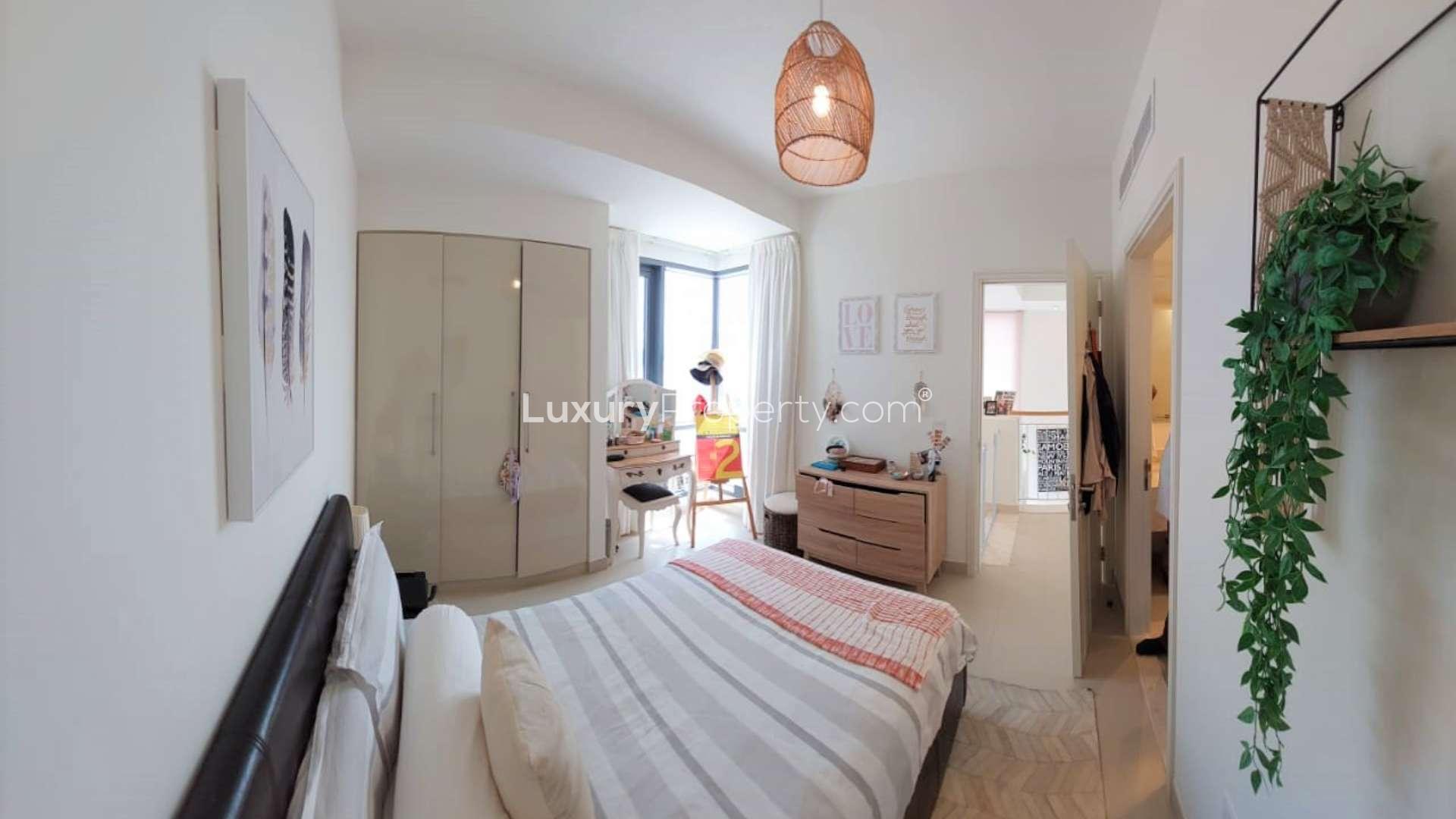 Modern living room in upgraded townhouse, Dubai Hills Estate, Maple. Bright space with balcony access