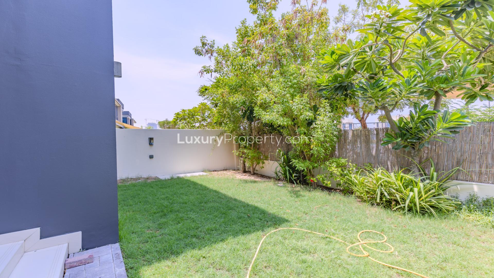 Modern 4-bed townhouse exterior in Maple at Dubai Hills Estate with lush greenery