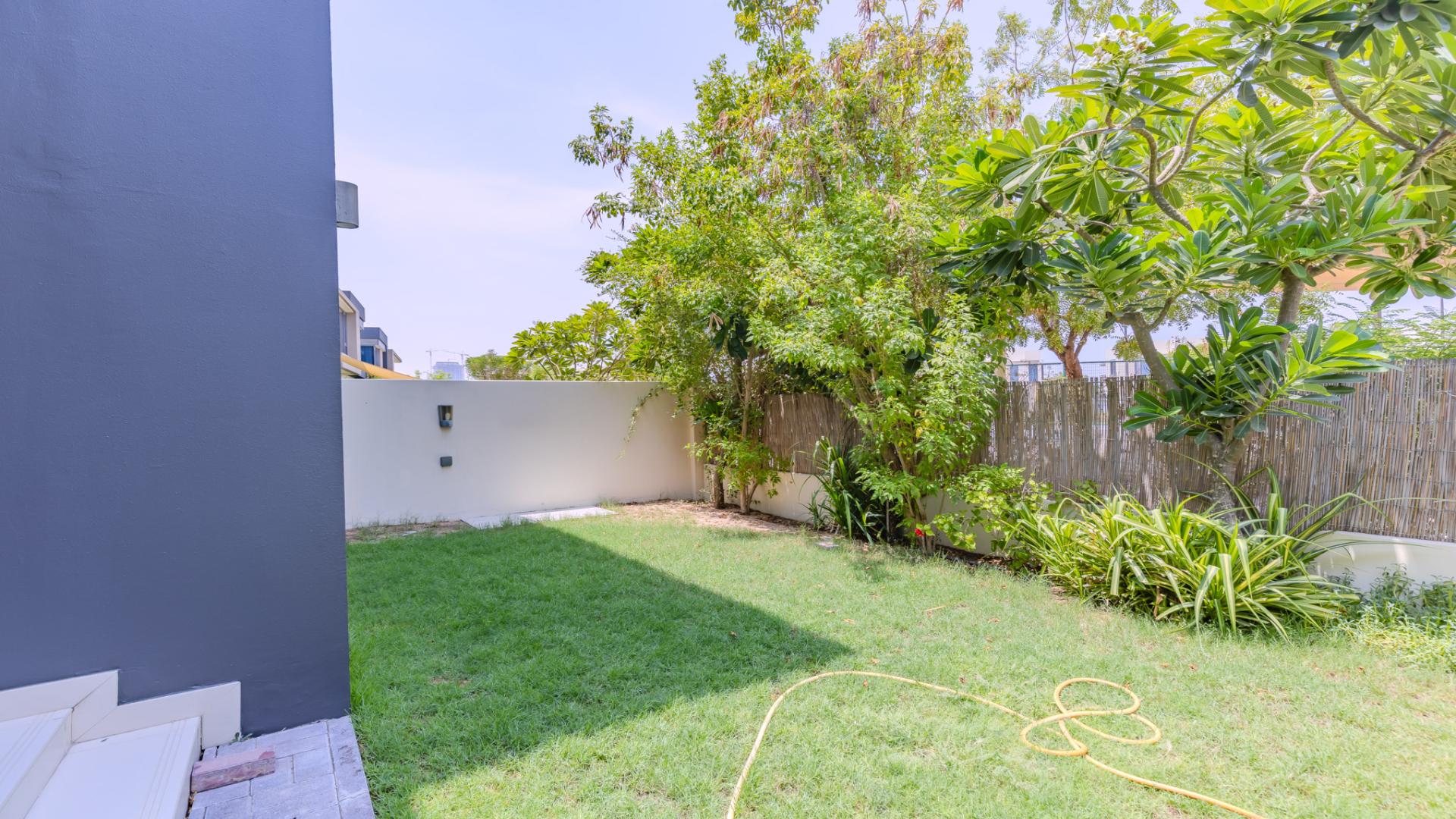 Modern 4-bed townhouse exterior in Maple at Dubai Hills Estate with lush greenery