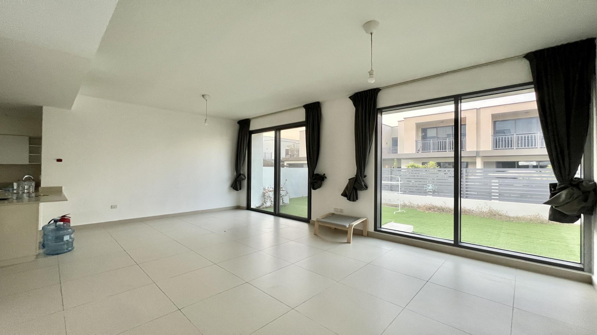 Exterior view of 4-bed villa with garden in Maple, Dubai Hills Estate at sunset