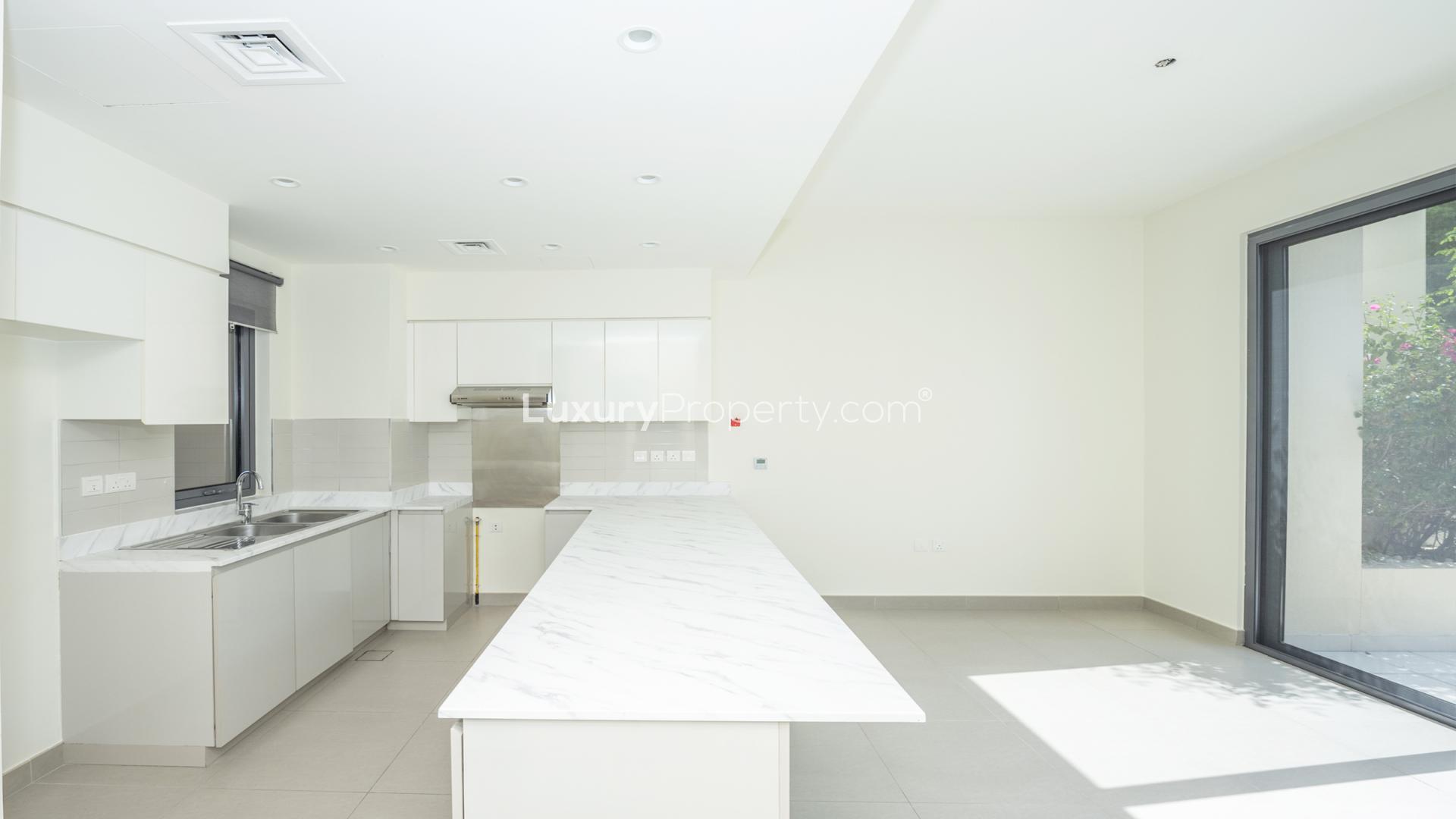 Modern kitchen in 4-bedroom villa, Maple at Dubai Hills Estate, marble countertops, bright interior
