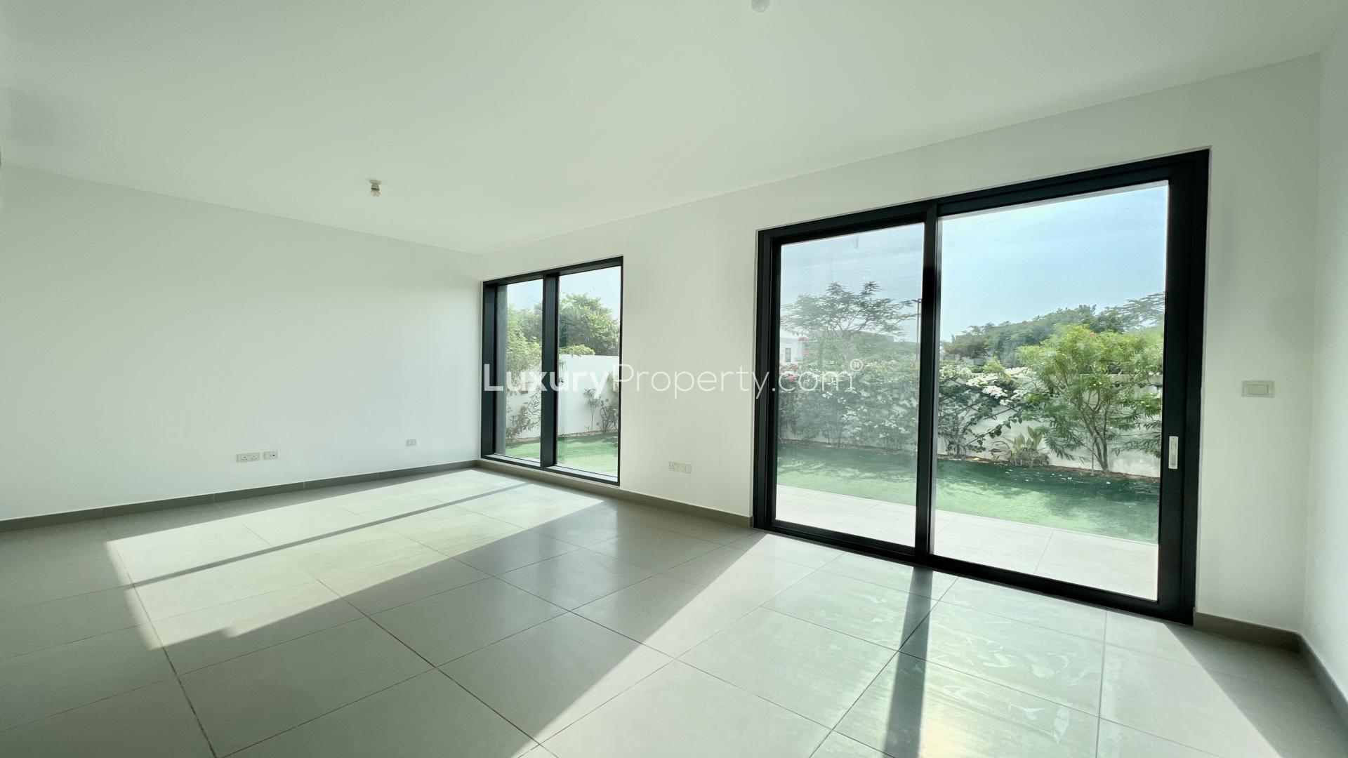 "Spacious garden in 4-bedroom villa, Maple 3, Dubai Hills Estate, lush greenery view.",Spacious living room with large windows in Maple 3 villa, Dubai Hills Estate