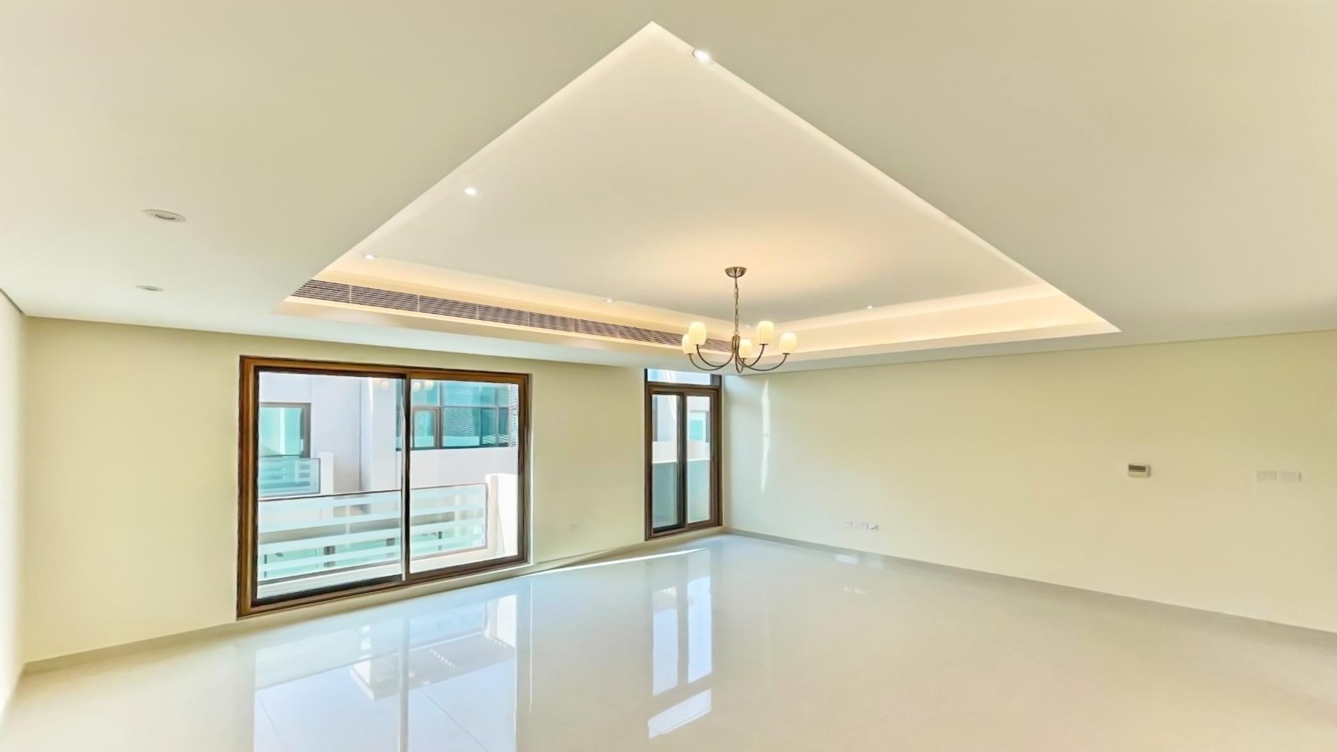 Modern townhouse patio with artificial grass in Meydan Gated Community, perfect for relaxation