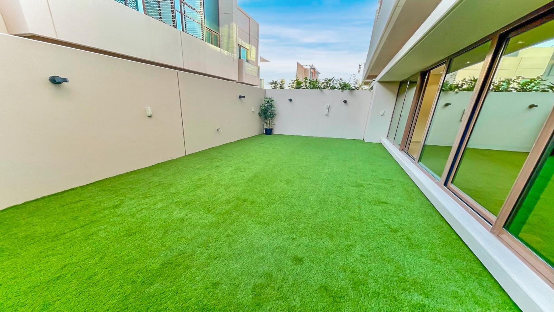 Spacious living area in Meydan townhouse, large windows, modern chandeliers, open layout