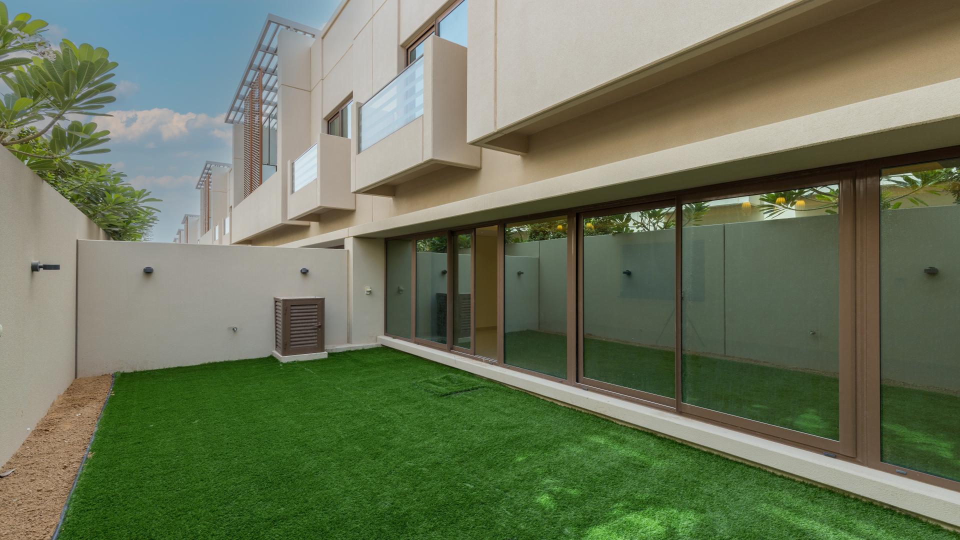 Spacious living area with large windows in Meydan City townhouse for rent