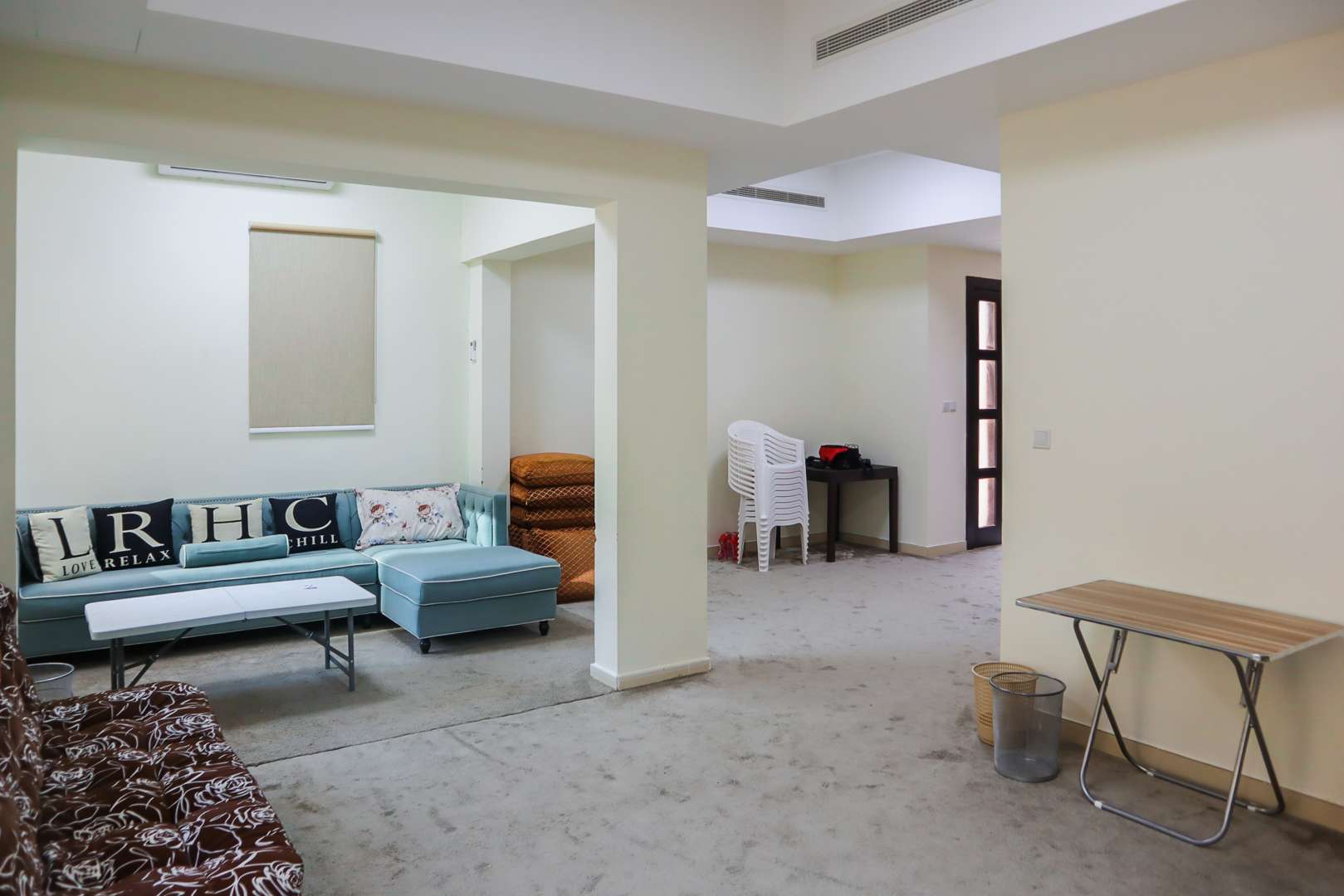 End-unit townhouse in Mira, Reem Community, Dubai, with tree-lined street and garages