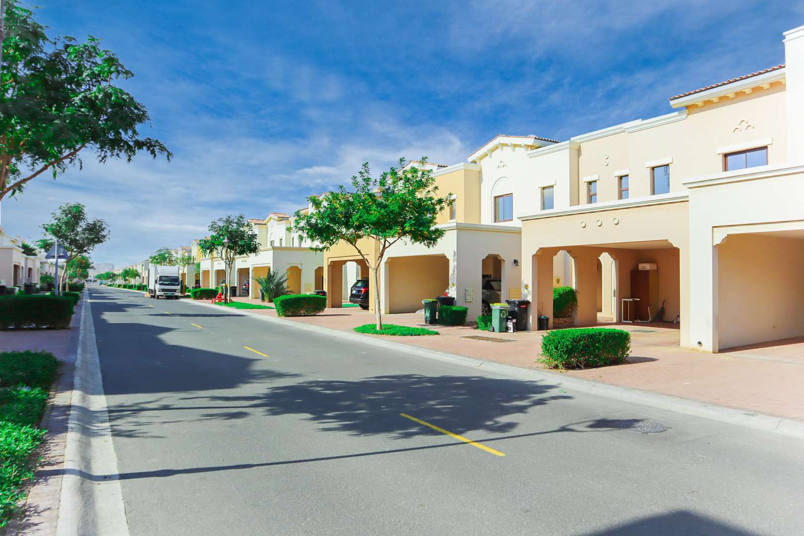 End-unit townhouse exterior in Mira, Reem Community, Dubai, featuring garden and driveway