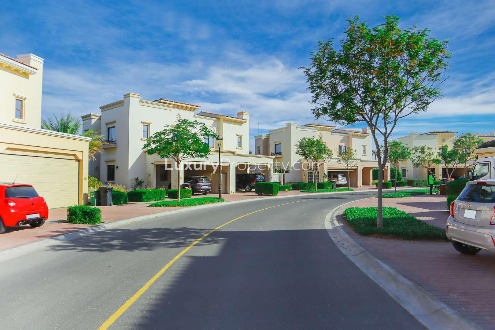End-unit townhouse exterior in Mira, Reem Community, Dubai, with lush landscaping and driveway