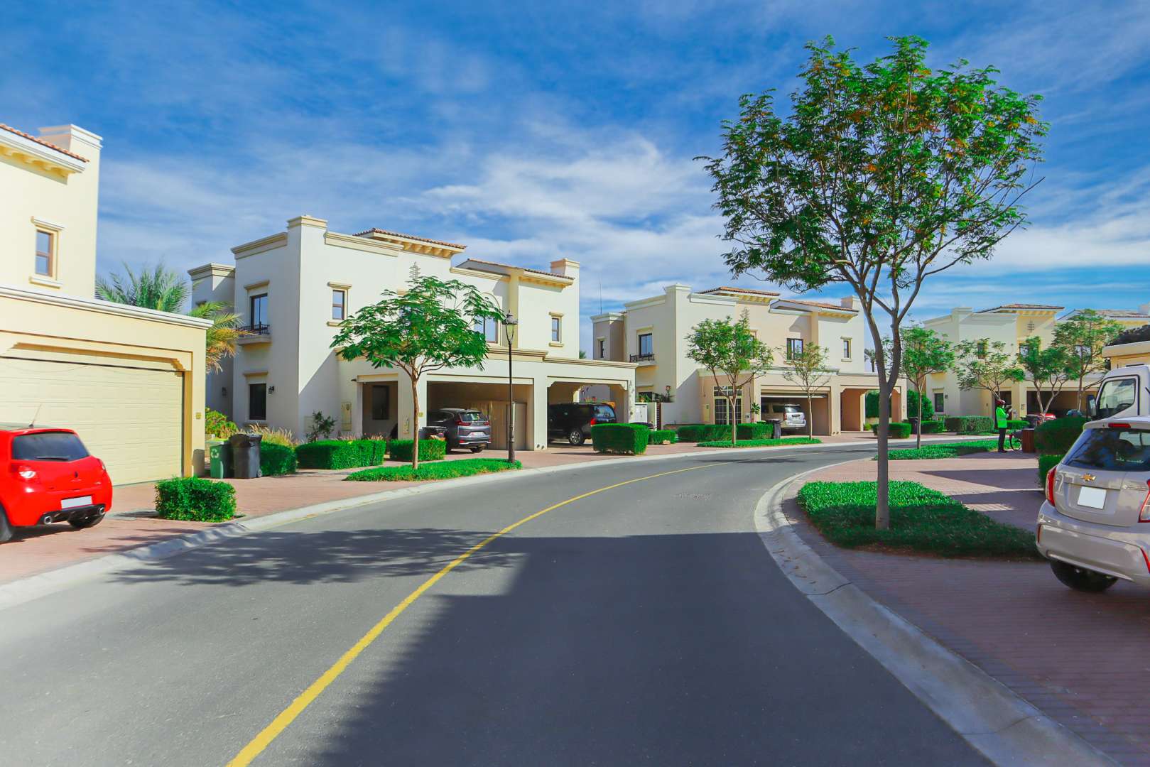 End-unit townhouse exterior in Mira, Reem Community, Dubai, with lush landscaping and driveway