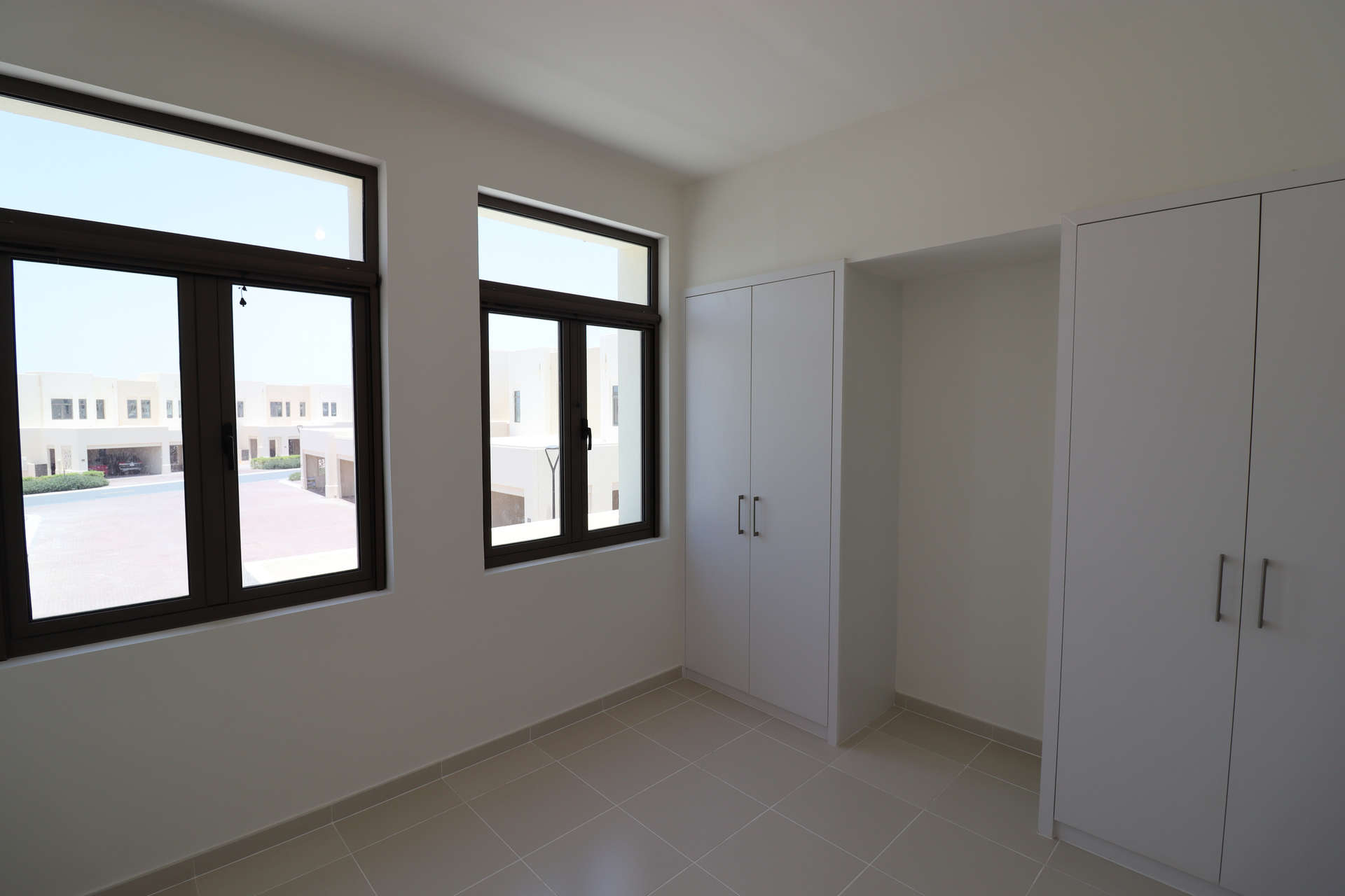 Brand new Mira Oasis townhouse bedroom with wardrobe and large windows, Reem community