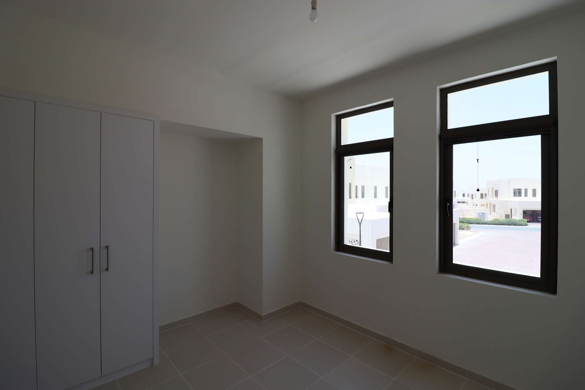 Brand new Mira Oasis townhouse bedroom with built-in wardrobe and tiled floor