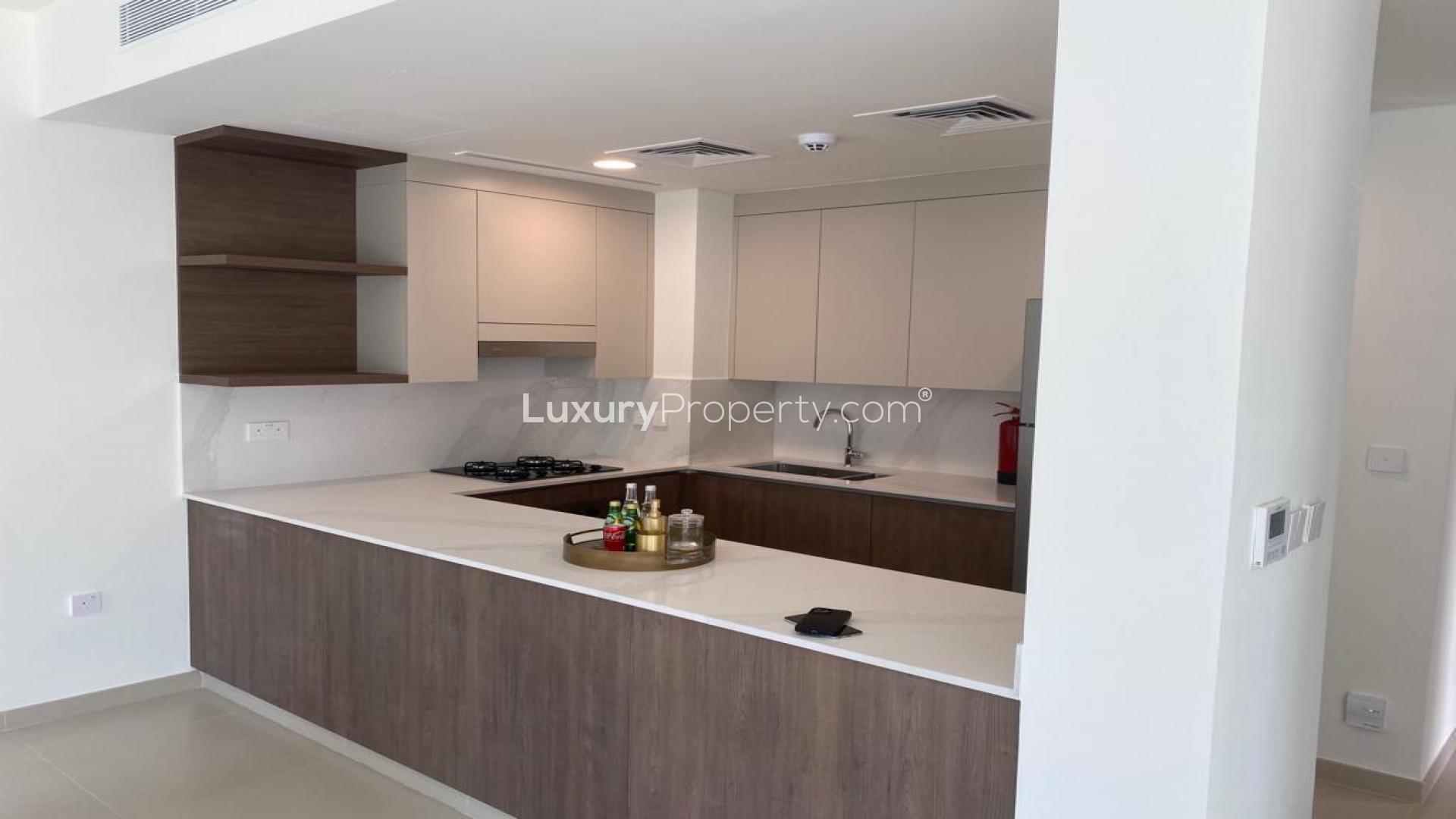 Modern kitchen in 4-bedroom townhouse, Elan, Tilal Al Ghaf, featuring sleek cabinetry and appliances