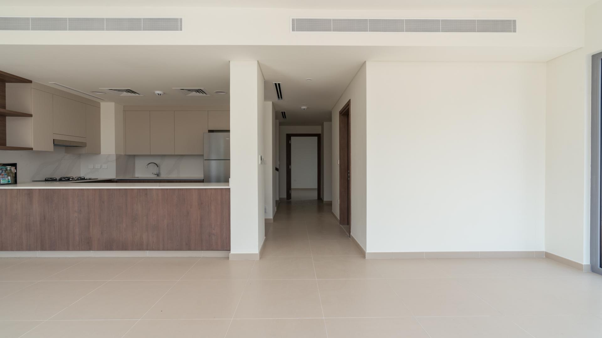 Modern kitchen and living area in 4-bedroom townhouse, Tilal Al Ghaf, Dubai