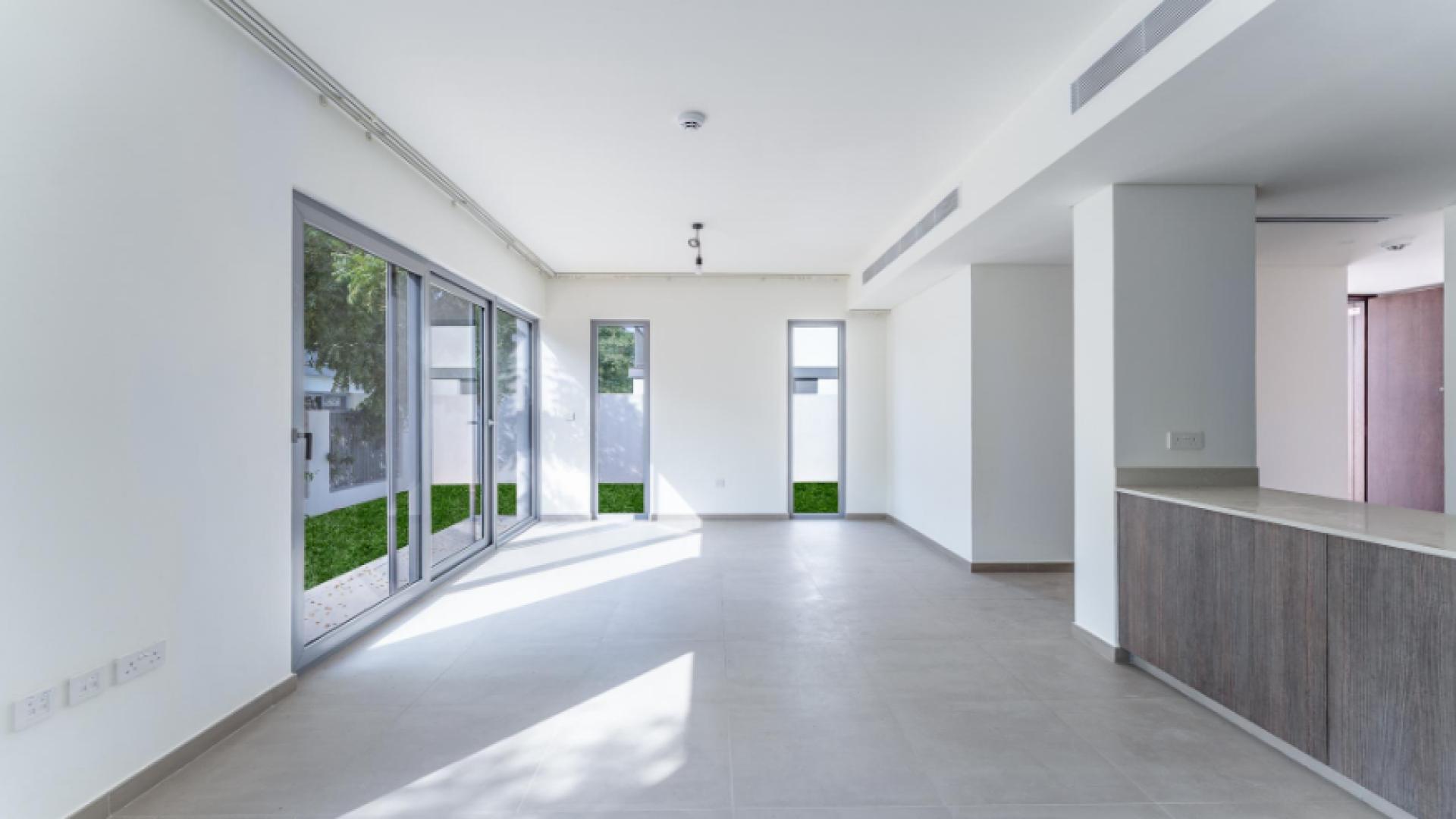 Townhouse exterior with green lawn in Elan, Tilal Al Ghaf, available for rent