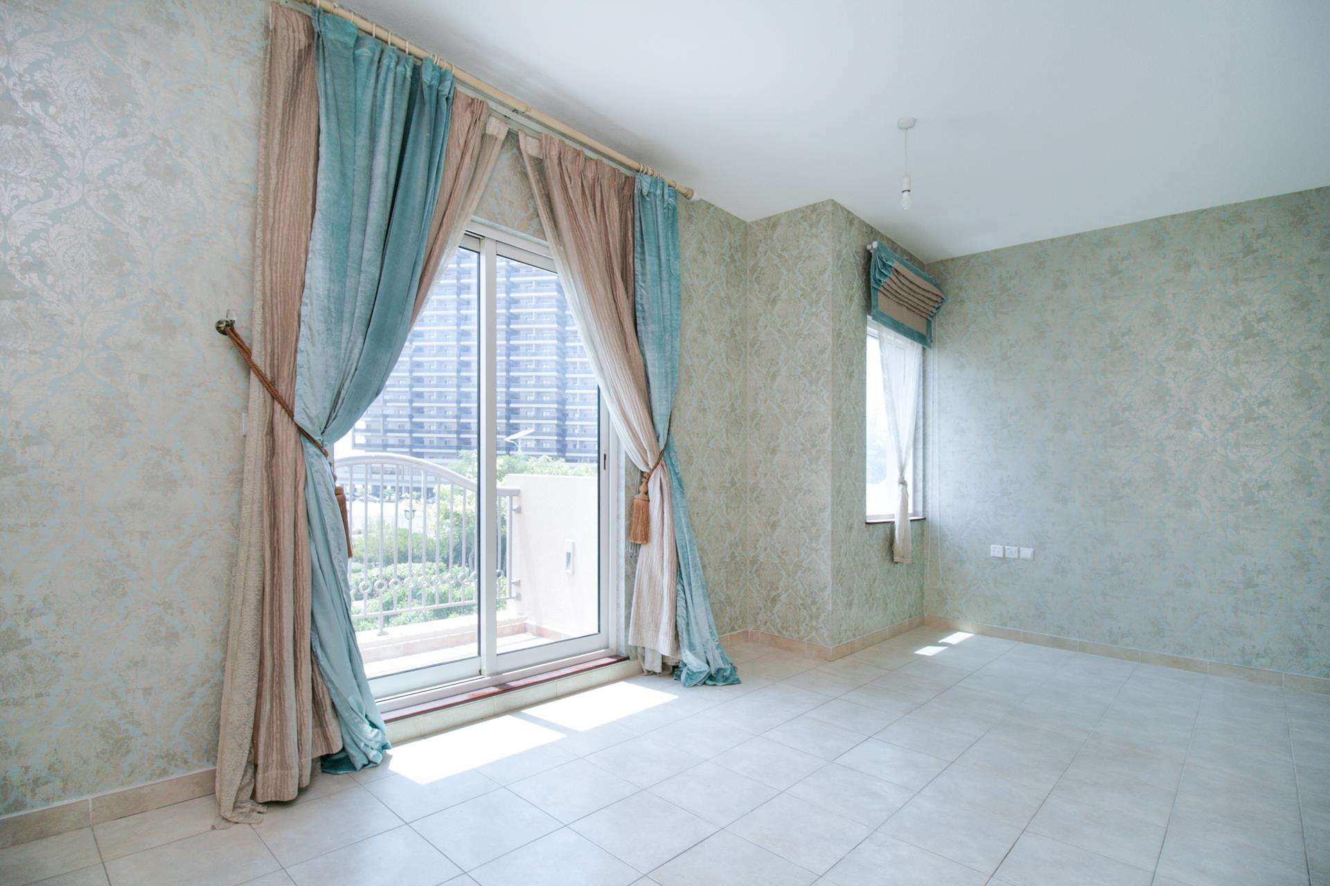 Empty room with tiled floor and window in Victory Heights townhouse, Dubai Sports City