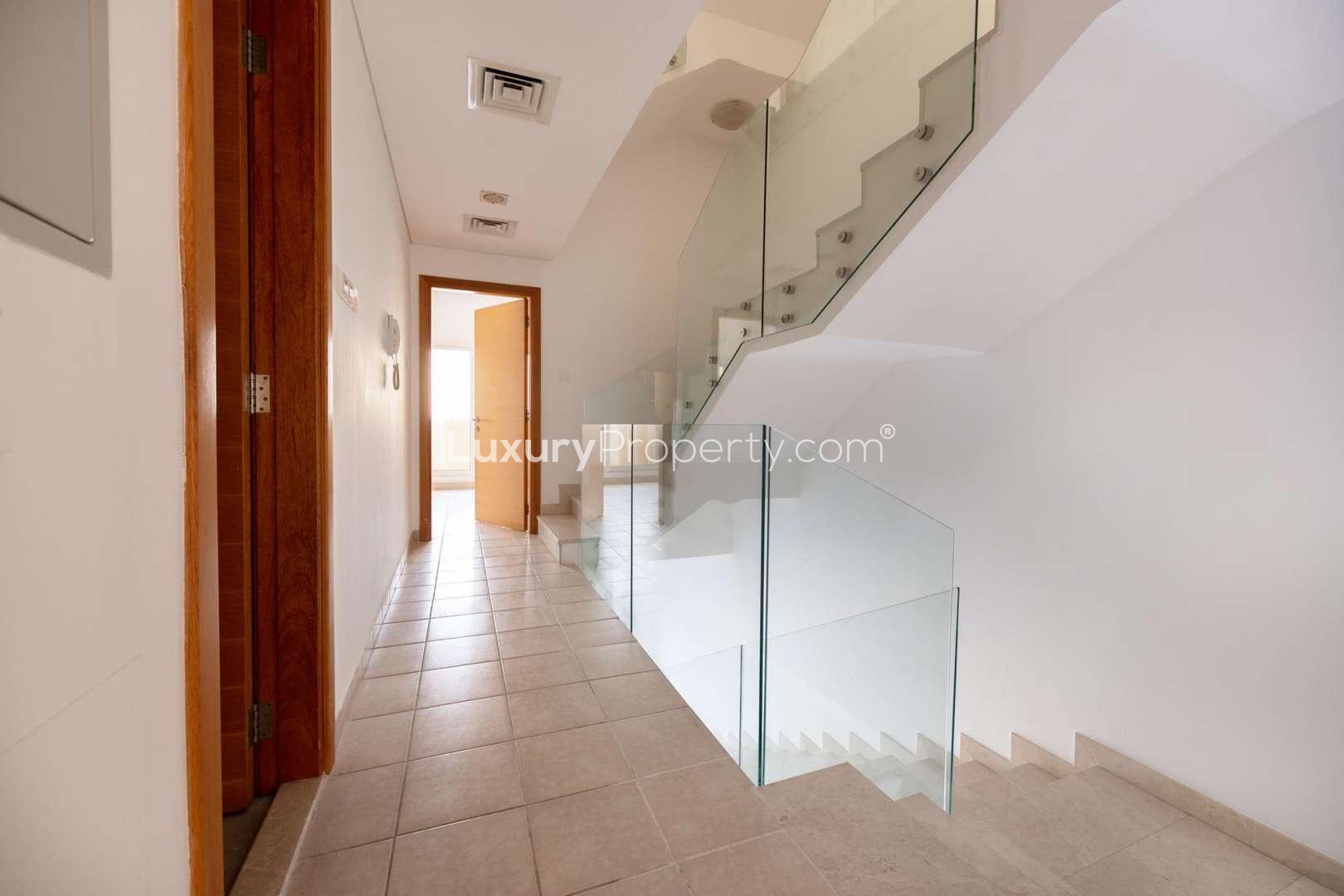 Spacious living room in JVC townhouse with modern staircase and natural light