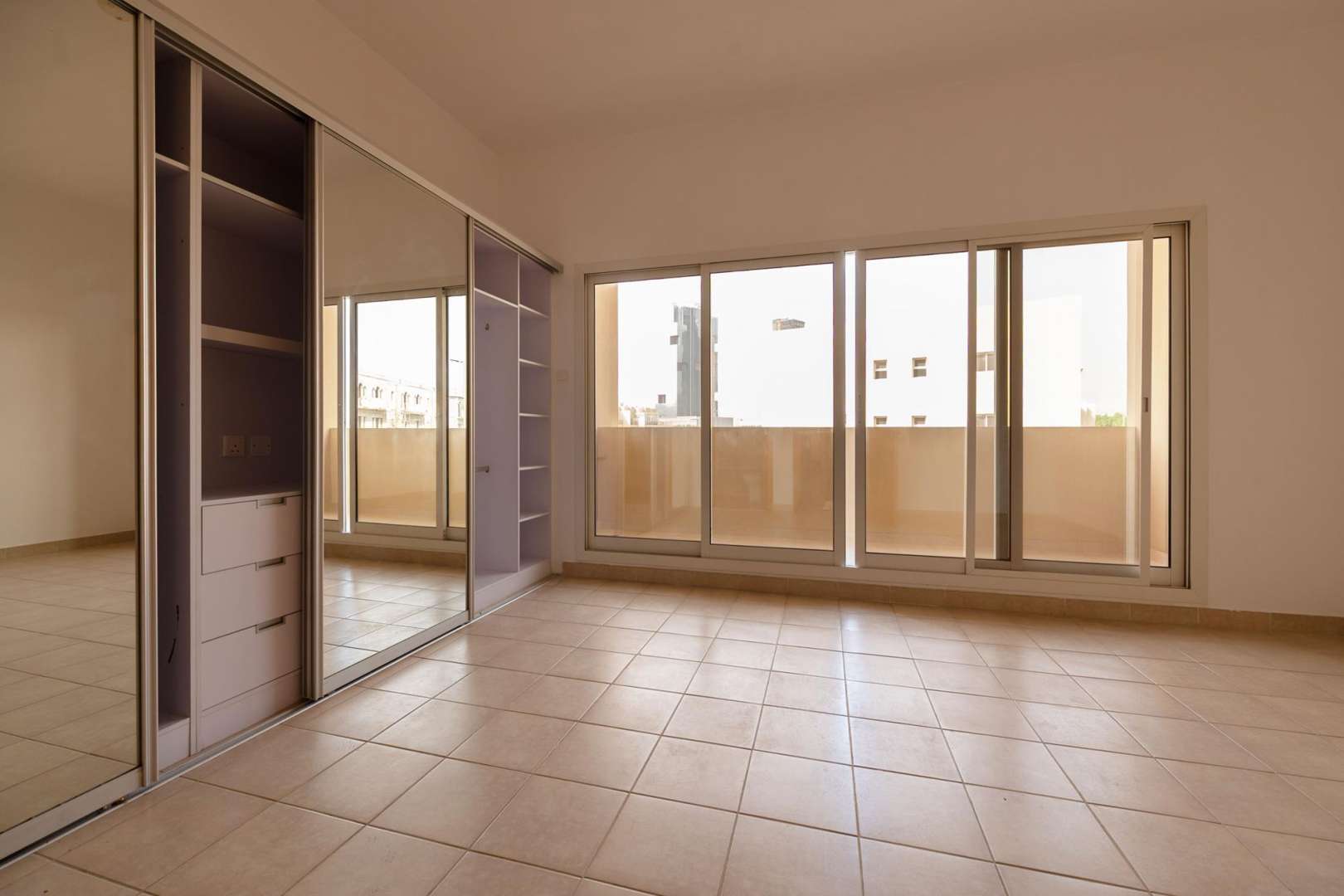 "Modern staircase in 4-bedroom townhouse for rent, Mulberry Park, Jumeirah Village Circle.",Spacious bedroom with built-in wardrobe and large windows in JVC townhouse for rent