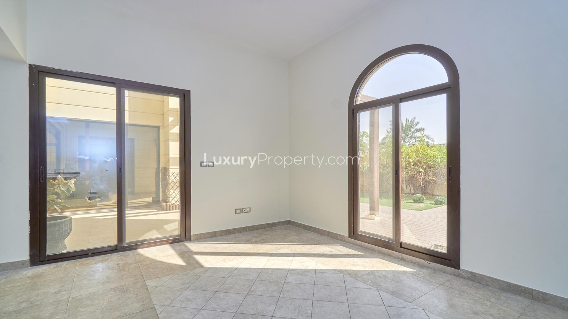 Bright living room with large windows in Naseem townhouse, Mudon community