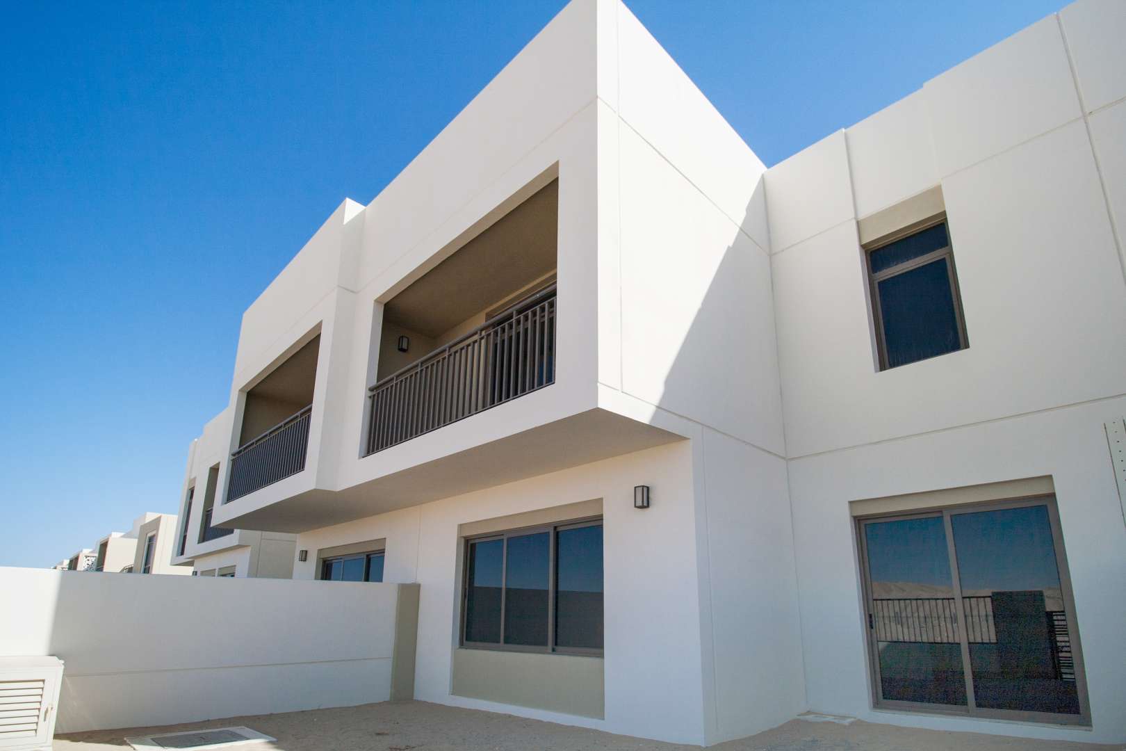 Corner townhouse exterior in Naseem, Town Square, featuring modern architecture and spacious balconies