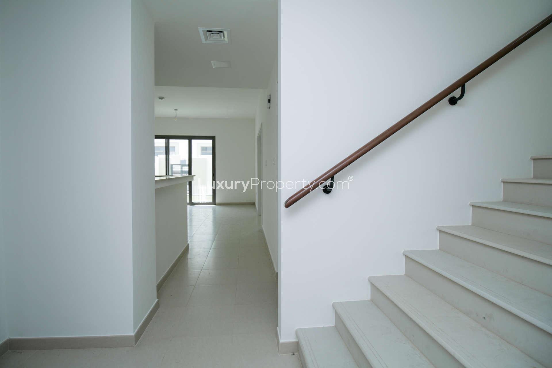 Spacious open-plan kitchen and living area in Noor Townhouses, Town Square townhouse for rent