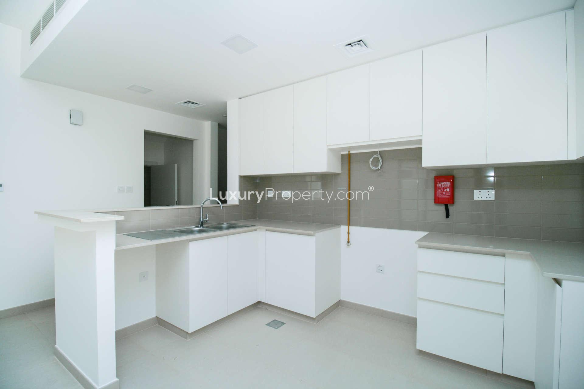 Exterior view of spacious 4-bedroom townhouse garden in Noor Townhouses, Town Square