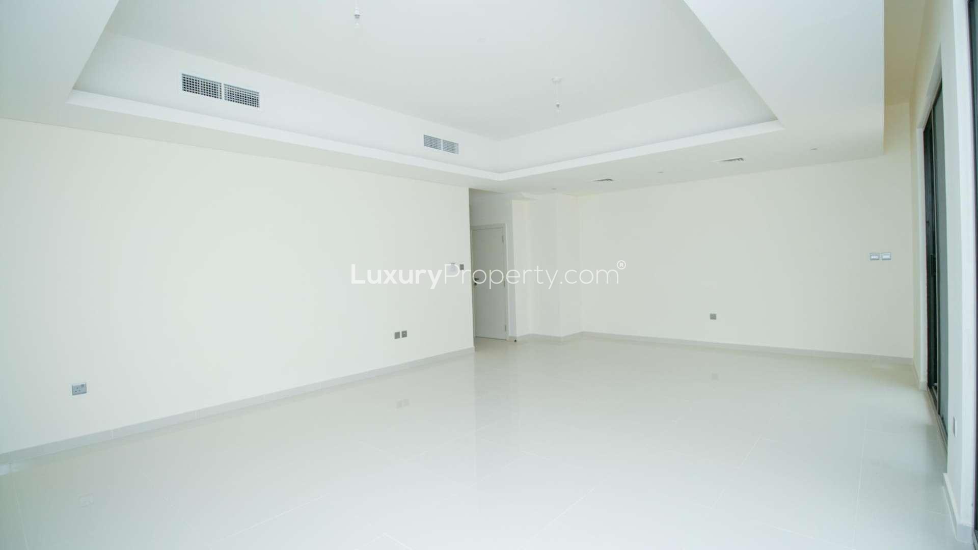 Bright living room with large windows in Akoya Oxygen townhouse for rent