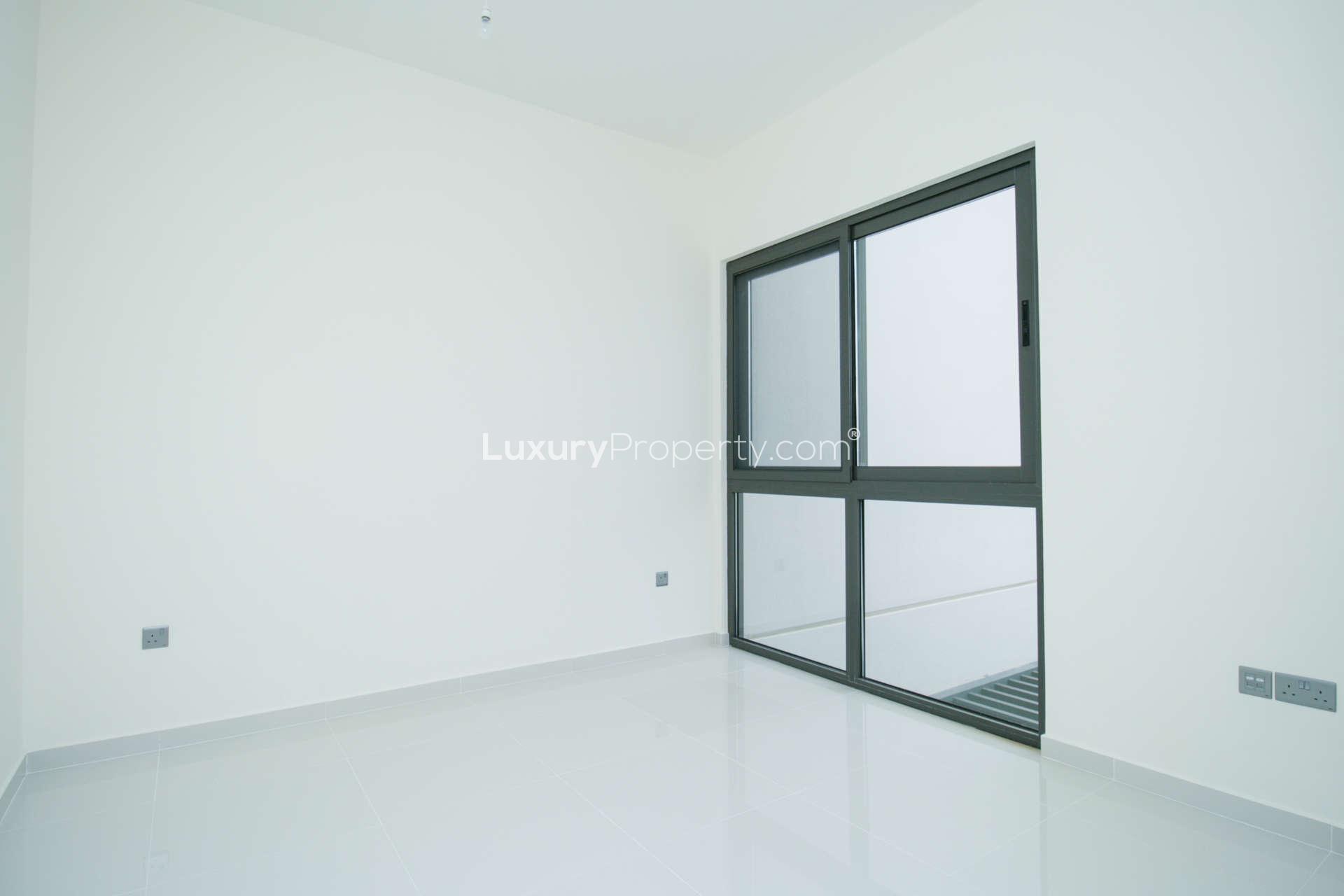 Bright, spacious bedroom with large window in 4-bedroom Damac Hills 2 villa, Primrose