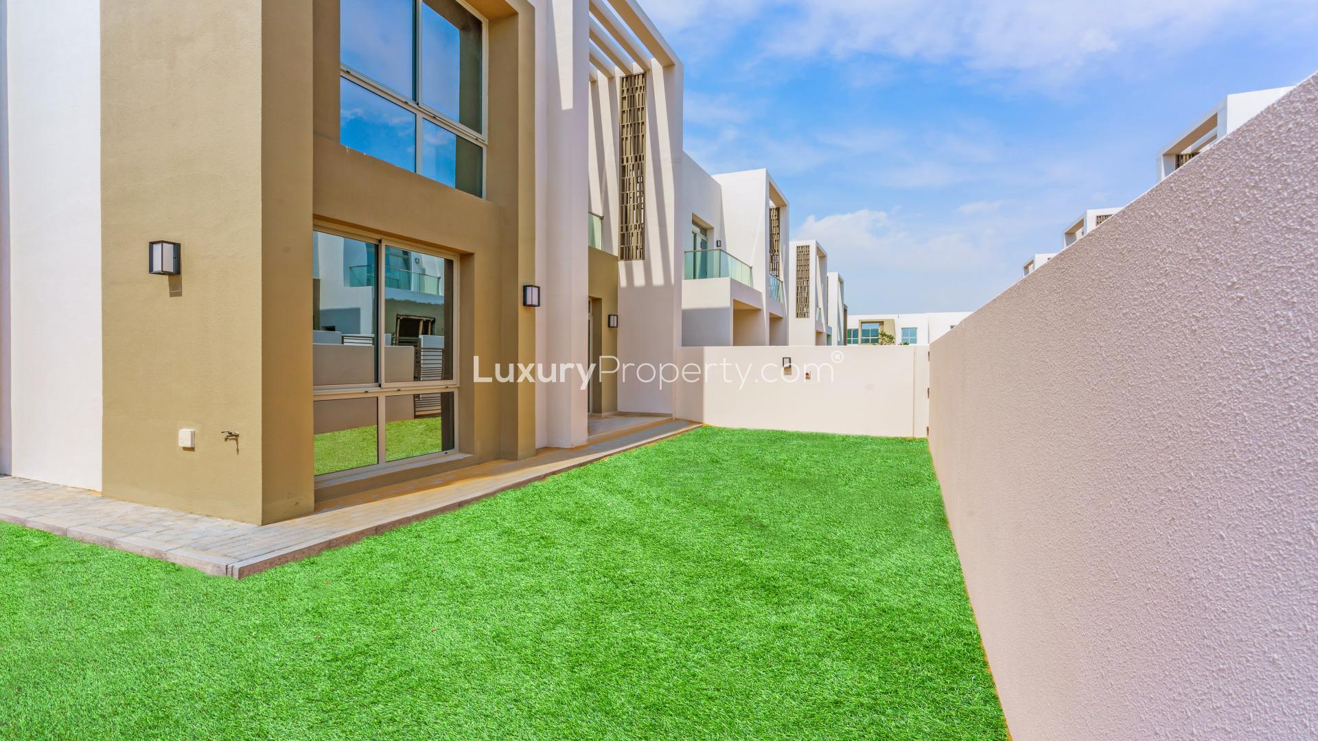 Spacious modern kitchen and living area in Reem Community townhouse, Arabian Ranches II