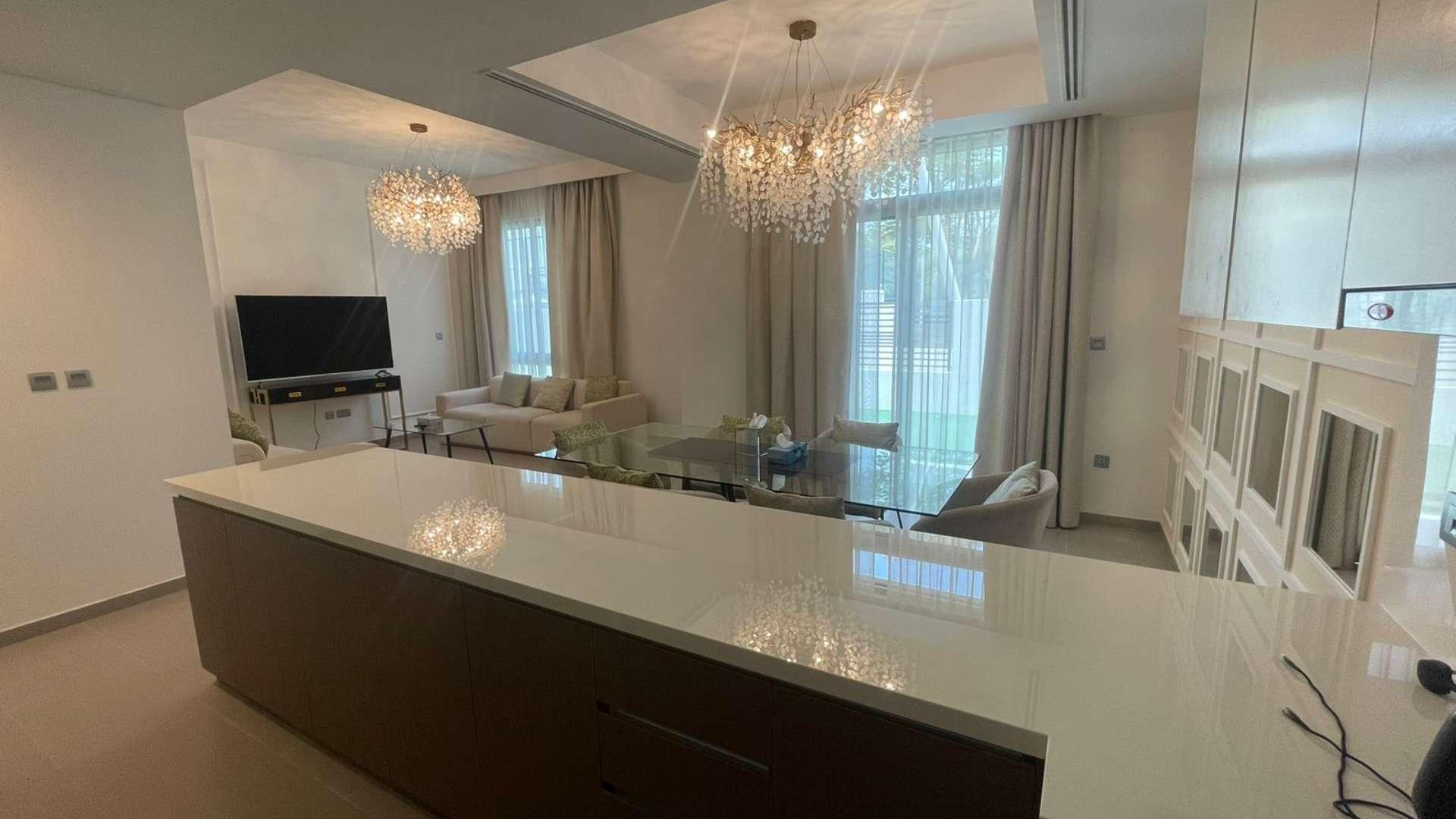 Elegant 4-bedroom townhouse exterior in Reem, Arabian Ranches 2, with green lawn view