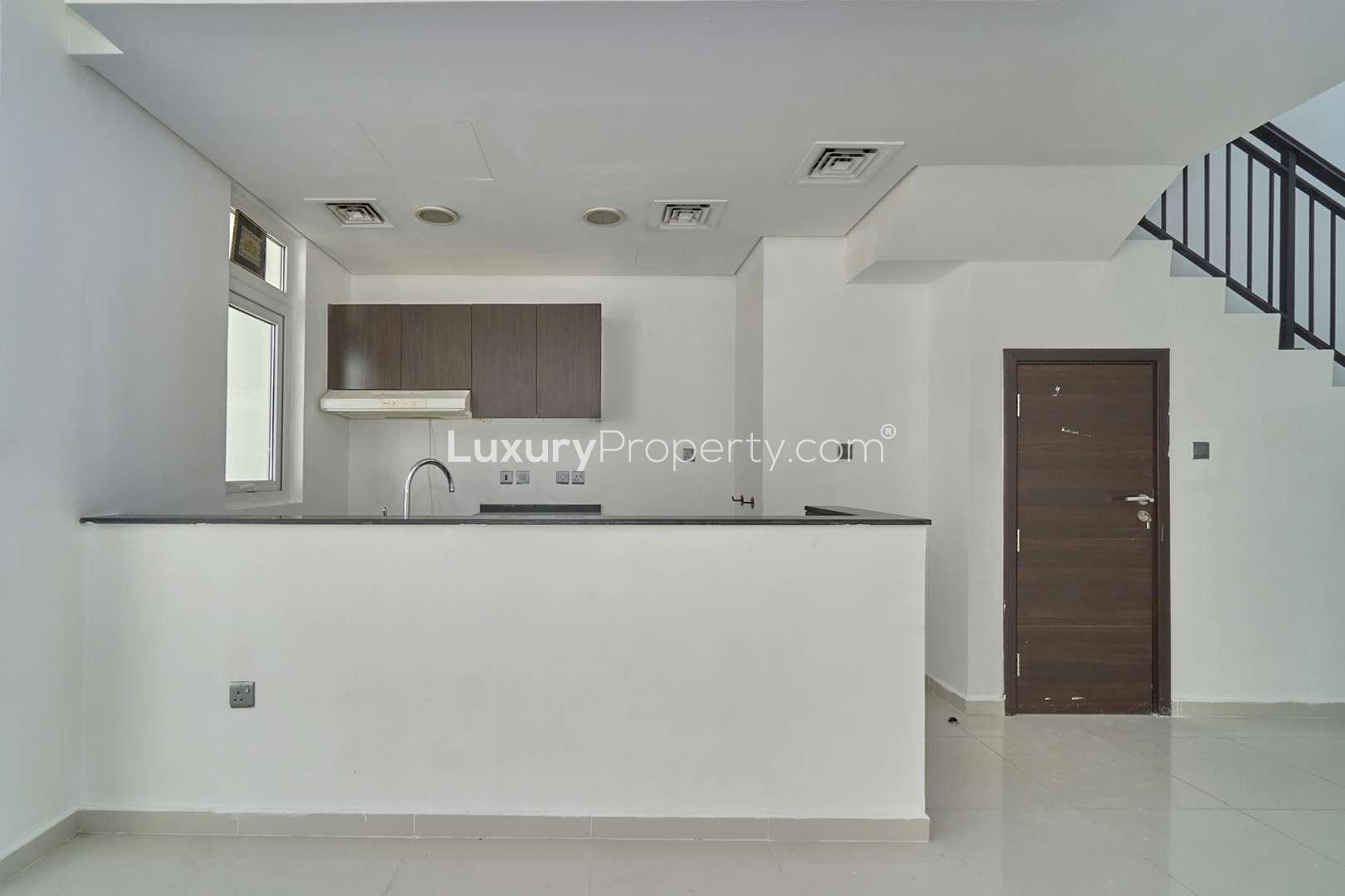 "Spacious living area with large windows in 4-bedroom villa, Damac Hills 2, Sanctuary.",Modern kitchen in 4-bedroom villa, Sanctuary, Damac Hills 2 townhouse for rent