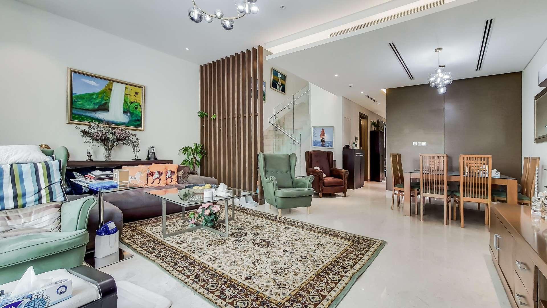 Living room in fully furnished townhouse, Sobha Hartland, with elegant decor and dining area