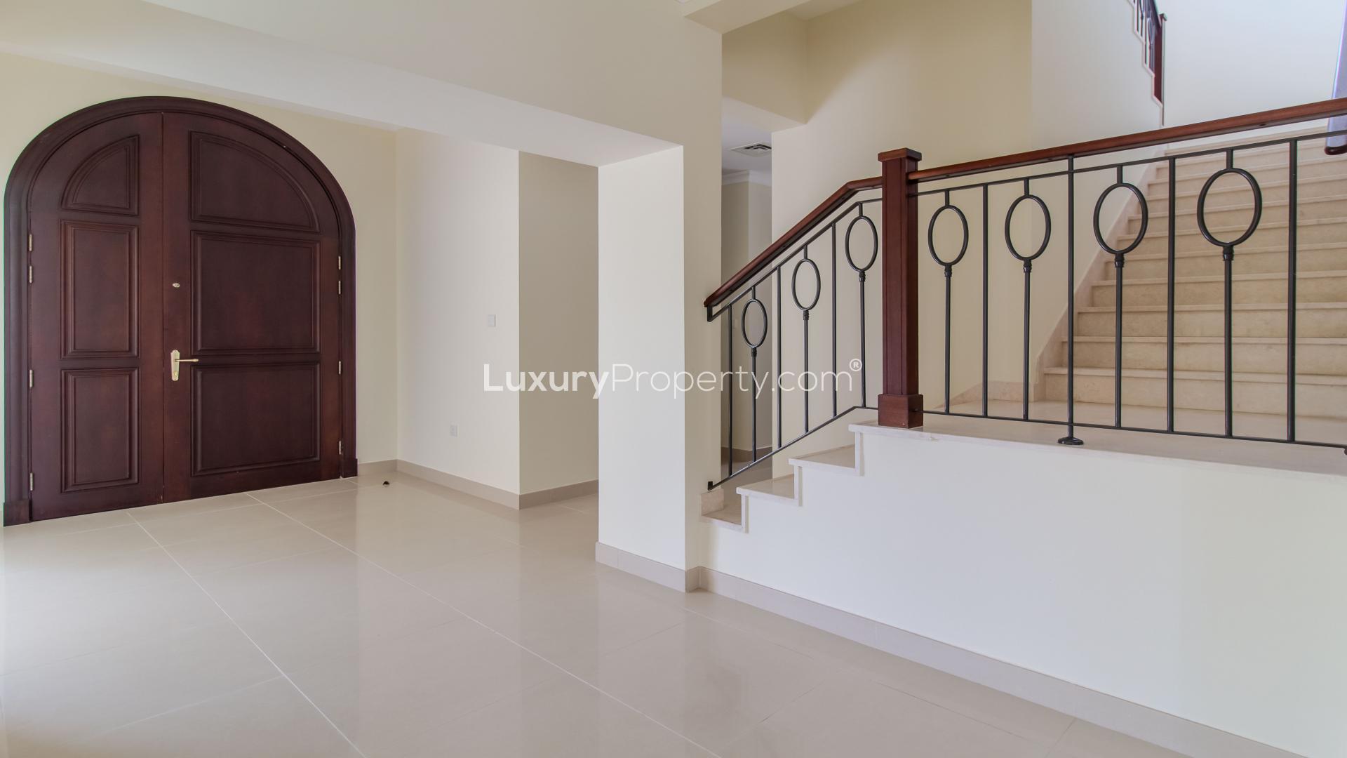 Elegant townhouse exterior with lush lawn in Arabian Ranches 2, Rosa community, for rent