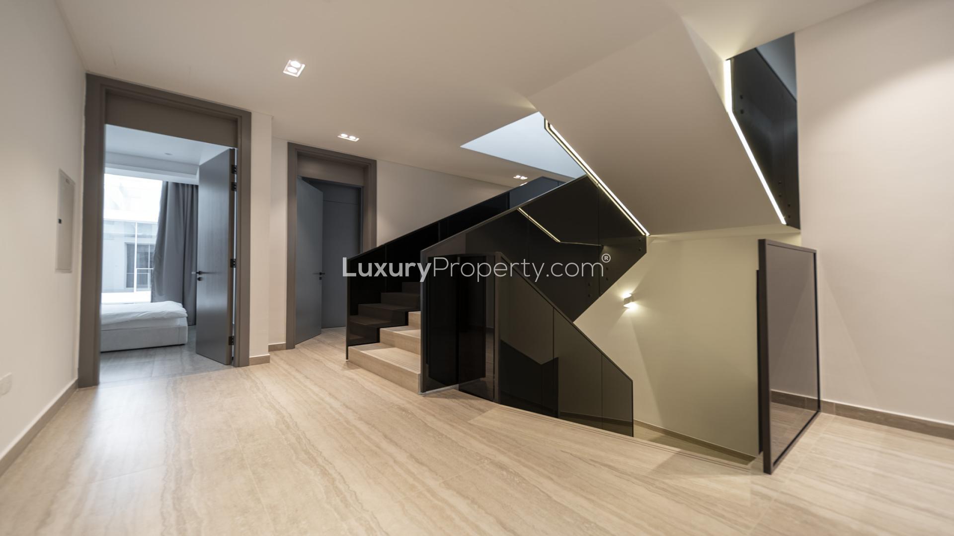 Luxurious living room in Ixora townhouse, Al Barari, with modern design and large windows