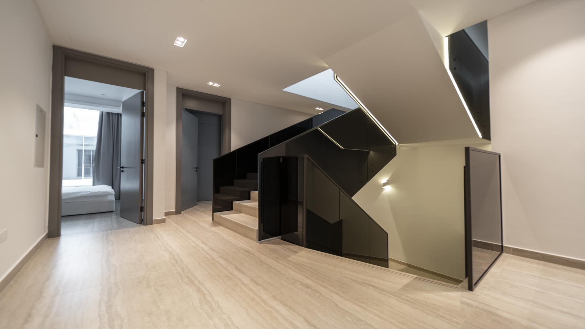 Luxurious living room in Ixora townhouse, Al Barari, with modern design and large windows