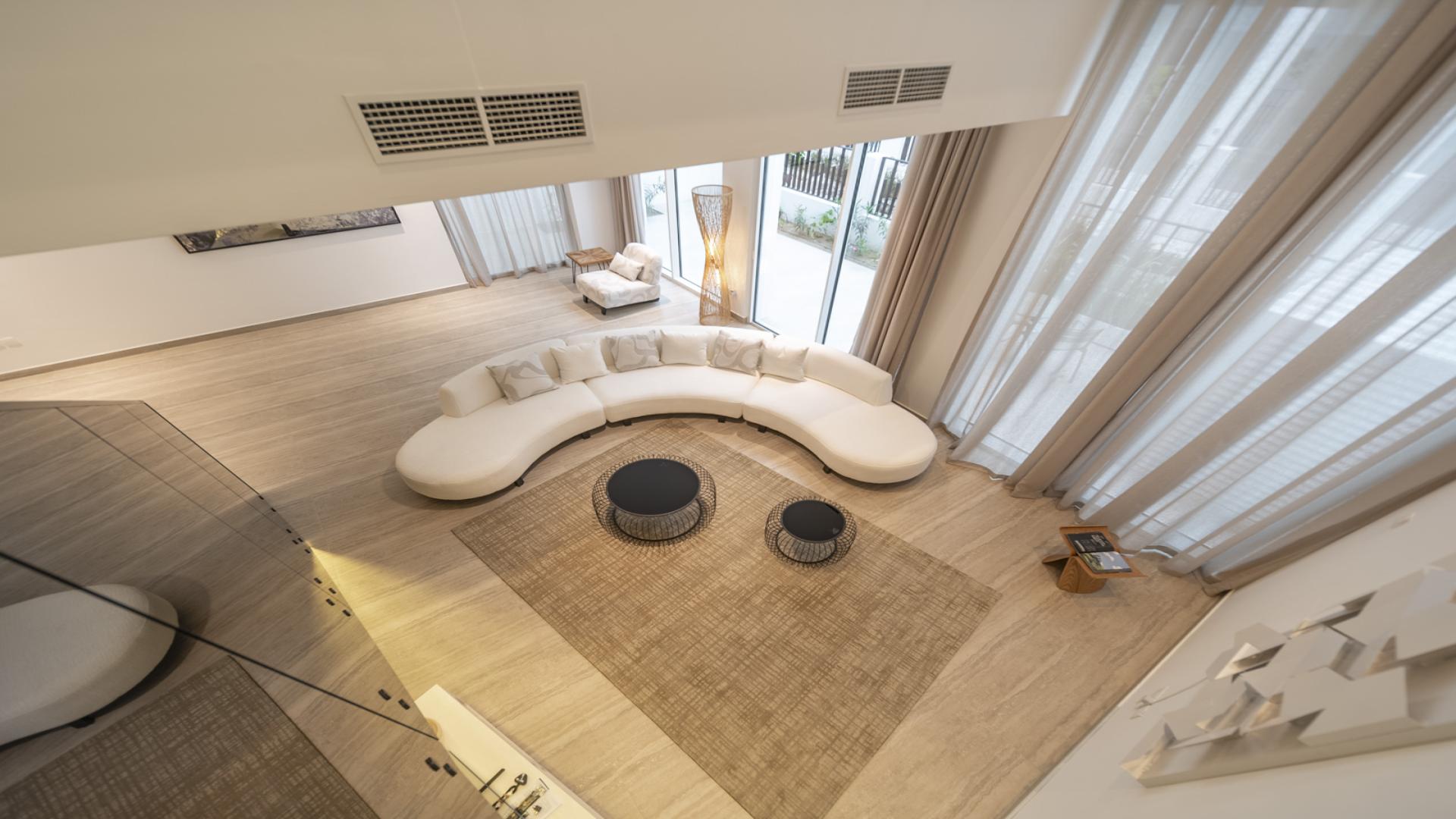 Modern living room in Al Barari Ixora townhouse with elegant decor and large windows