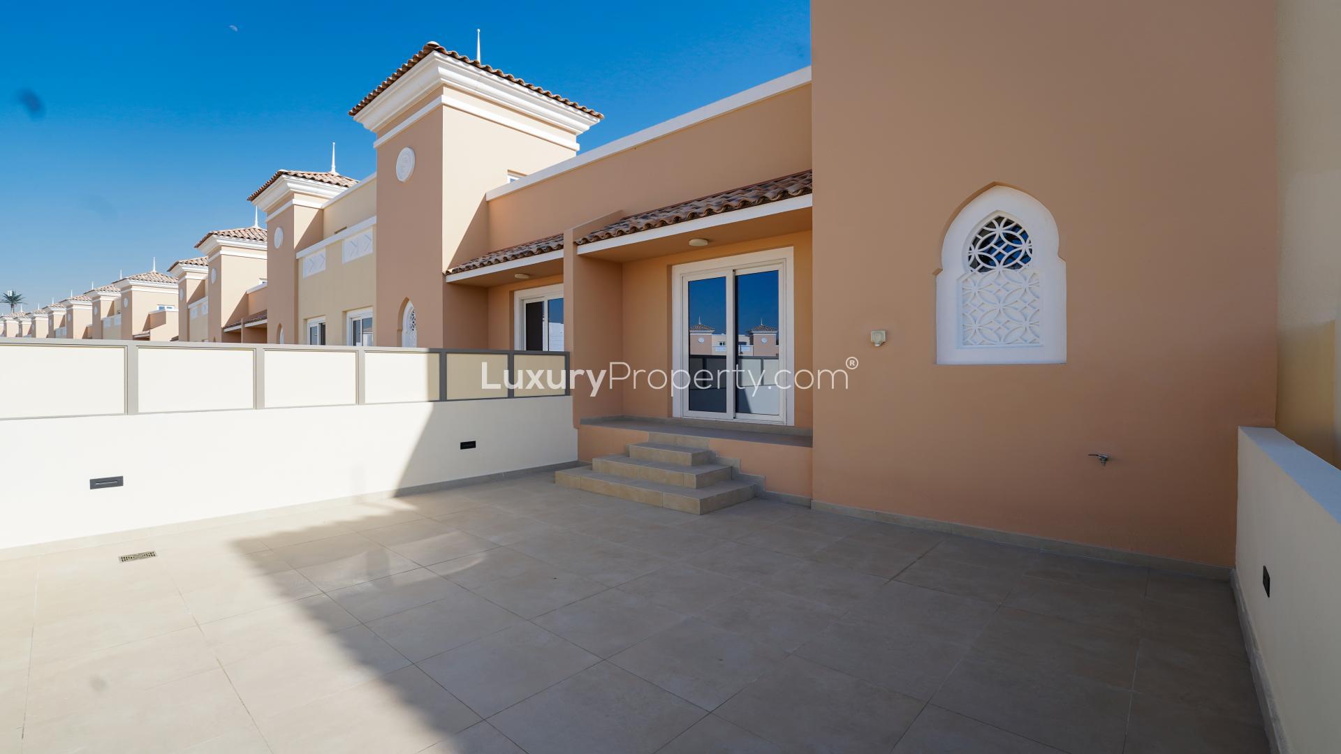 Modern four-bedroom townhouse exterior in Victory Heights, Dubai Sports City, available for rent