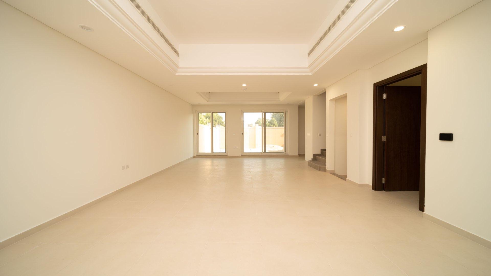 Modern townhouse exterior in Victory Heights, Dubai Sports City, with spacious garage