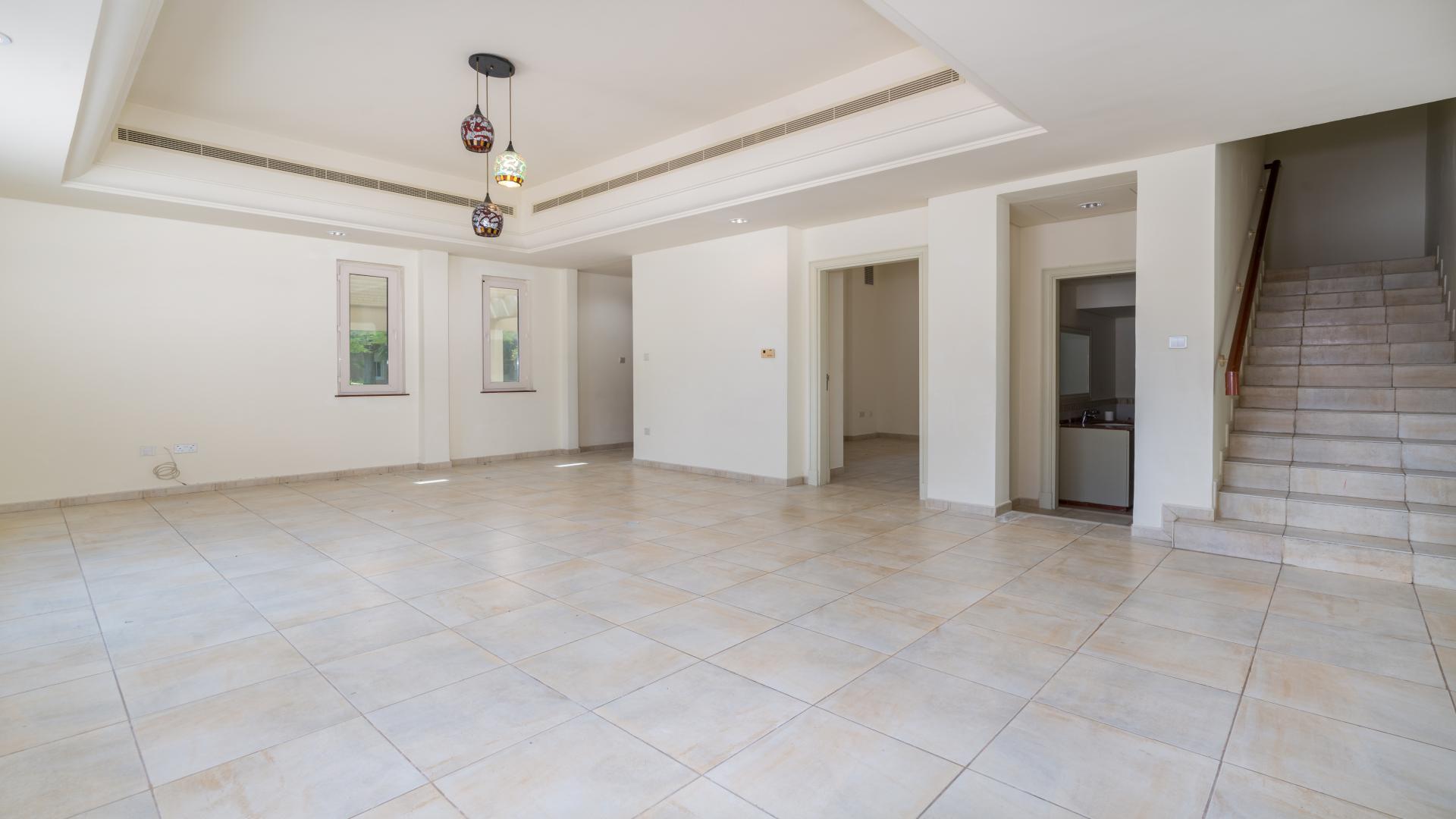 Modern kitchen with cream cabinets and stainless steel fridge in Victory Heights townhouse