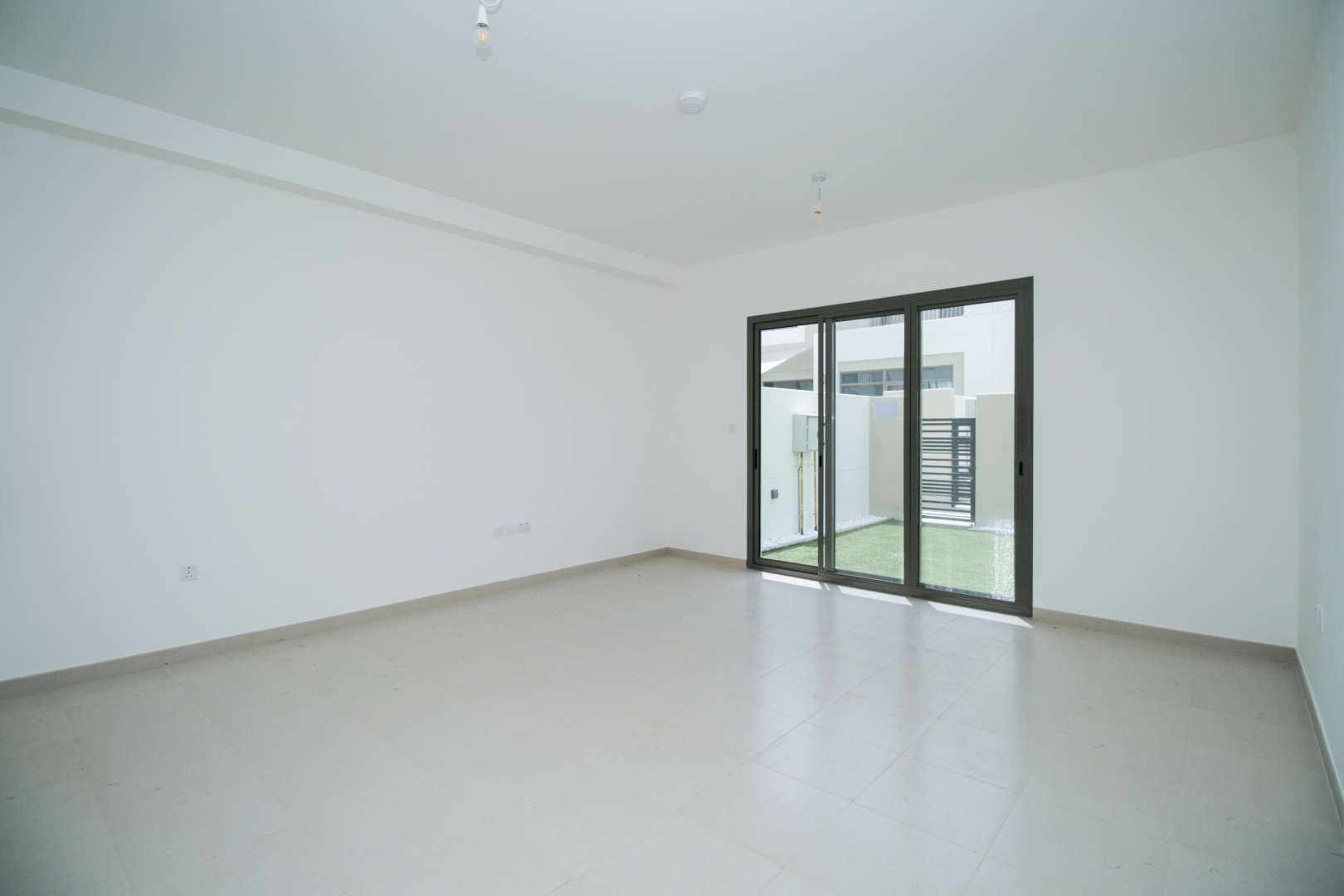 Modern kitchen and living area in Zahra Townhouses, Town Square, Dubai