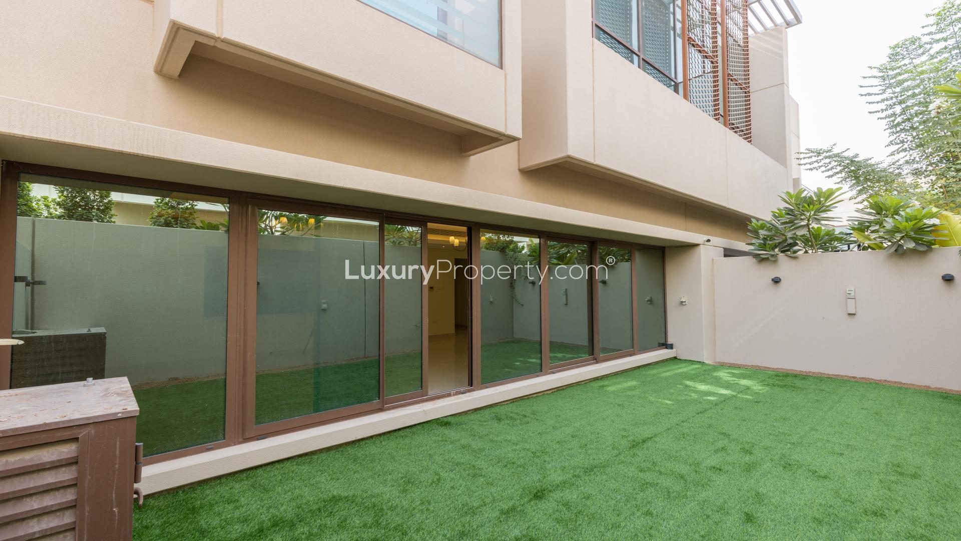 Spacious living room in Meydan townhouse with large windows and elegant lighting fixtures