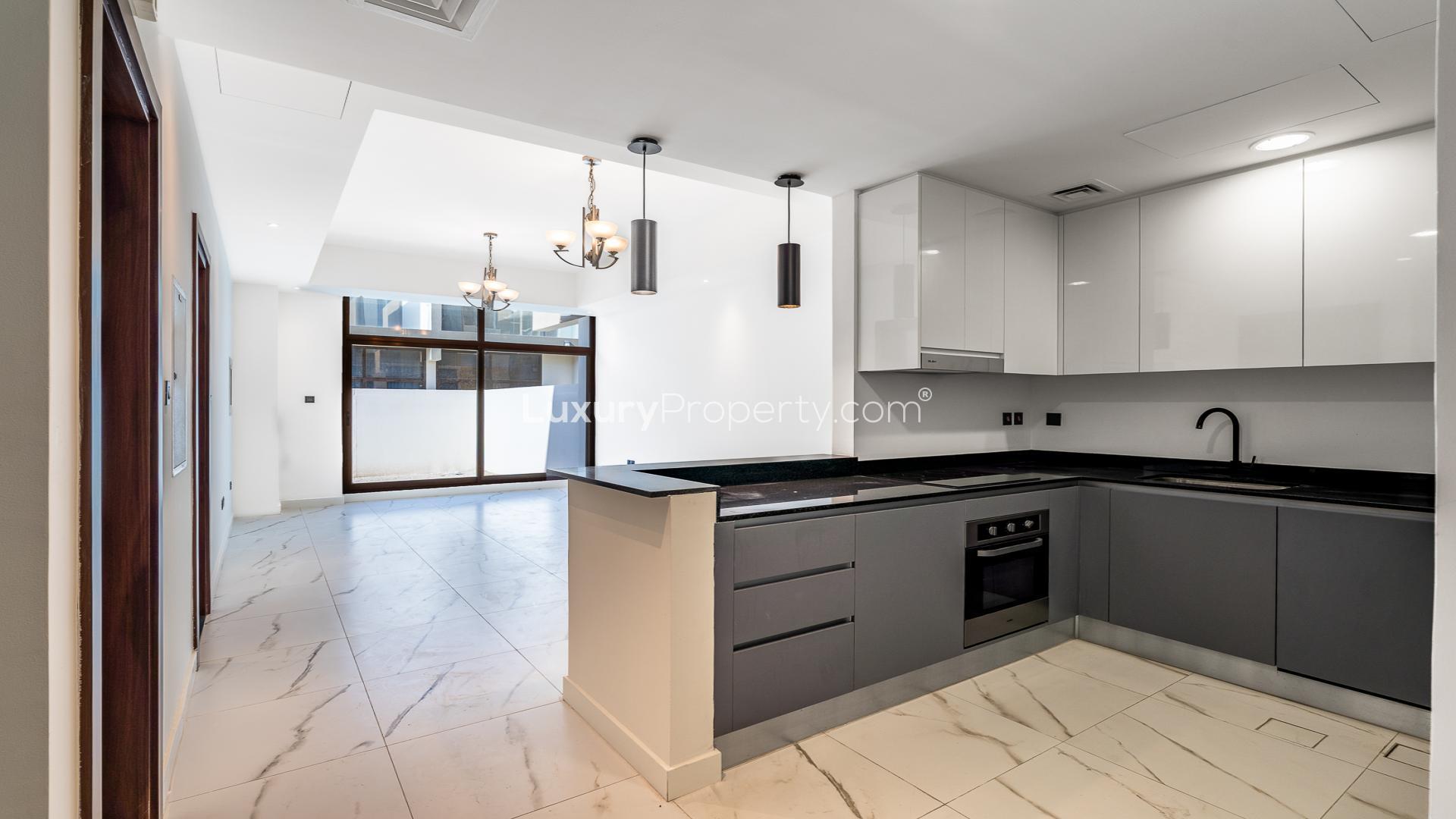 Modern open-plan living area in Meydan townhouse for sale at Elie Saab A Vie