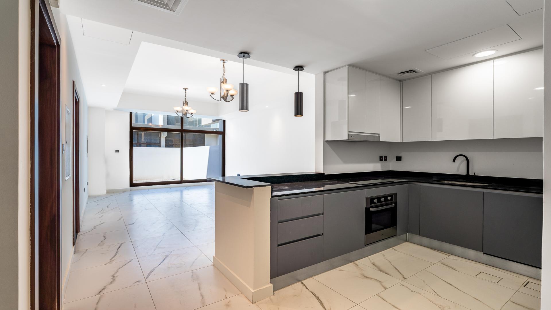 Modern open-plan living area in Meydan townhouse for sale at Elie Saab A Vie