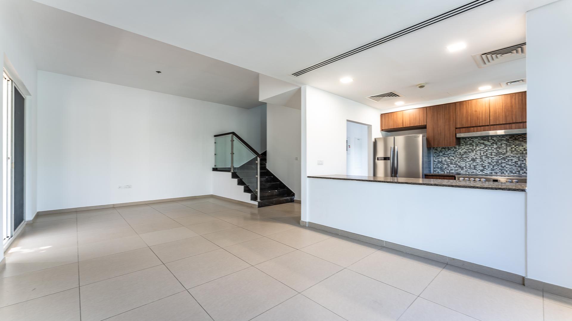 Modern kitchen and staircase in Arabella 3 townhouse, Mudon community, for sale