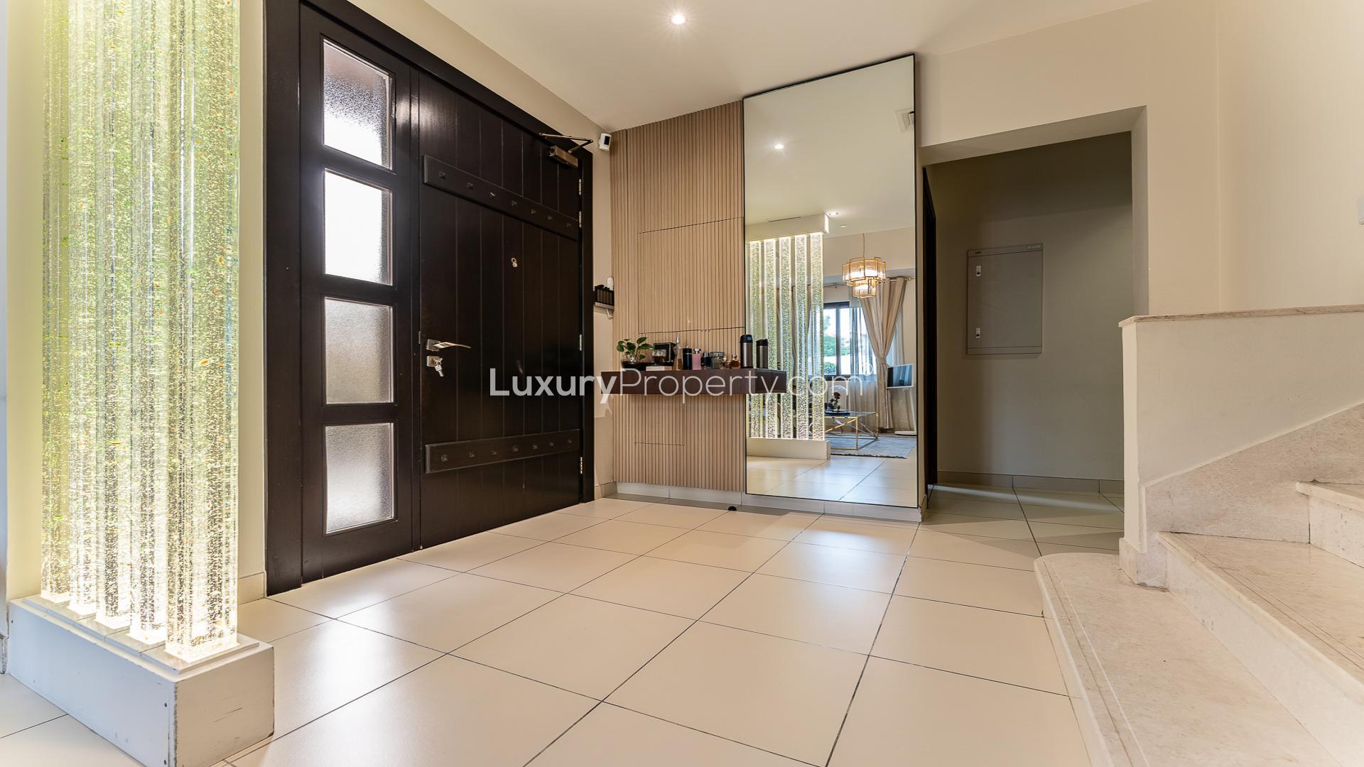 Townhouse for sale in Mira 2, Reem community, featuring spacious garage and landscaped surroundings
