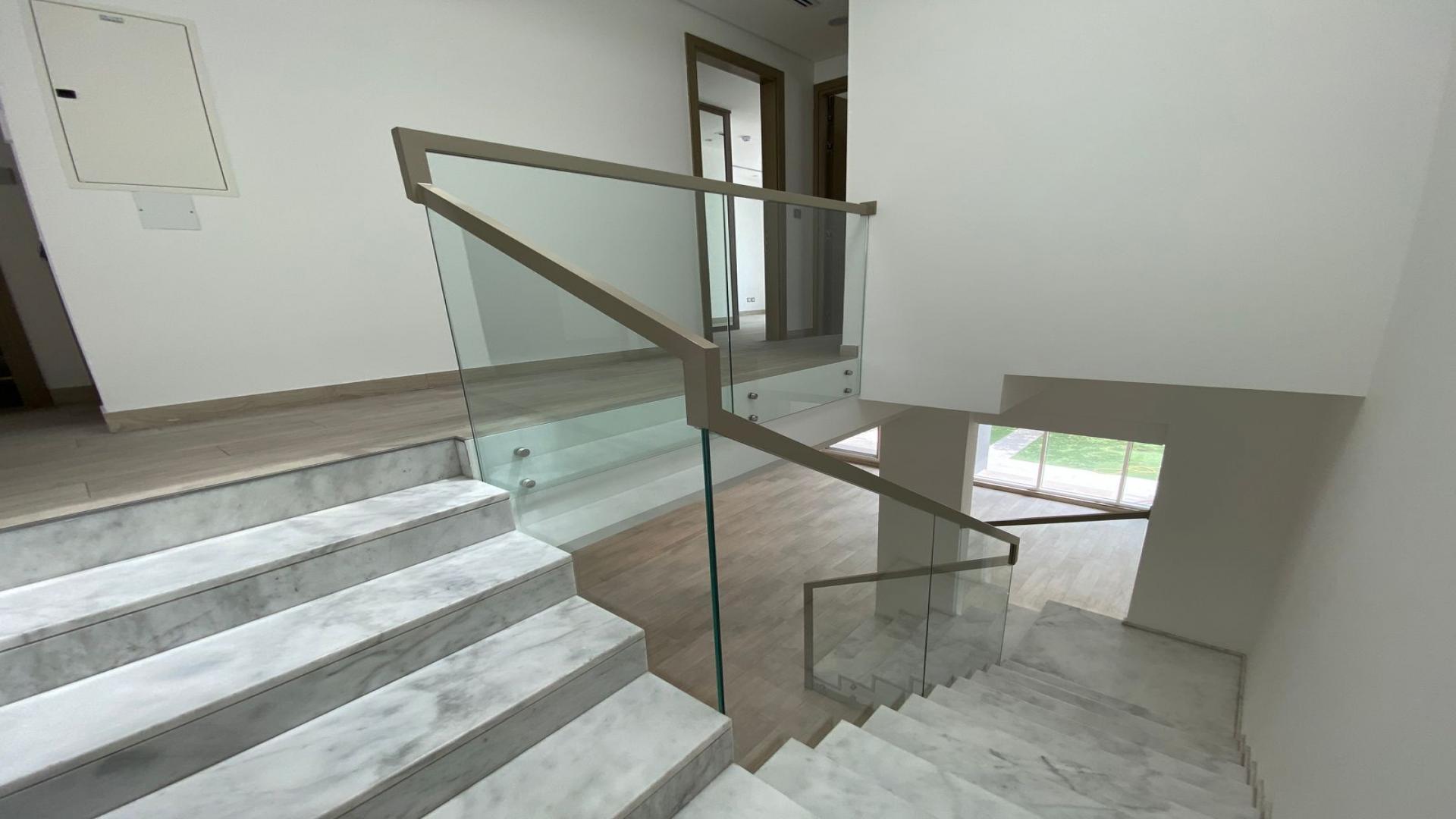 Open-plan living area with modern staircase in Jumeirah Park townhouse, Royal Park community