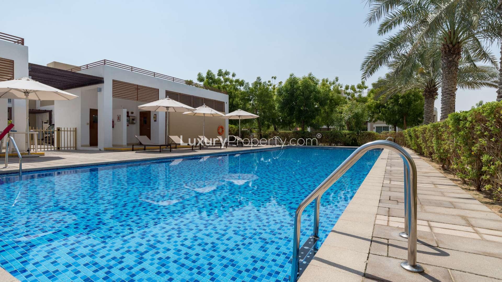 Spacious living room with large windows in Mudon townhouse, Al Salam community